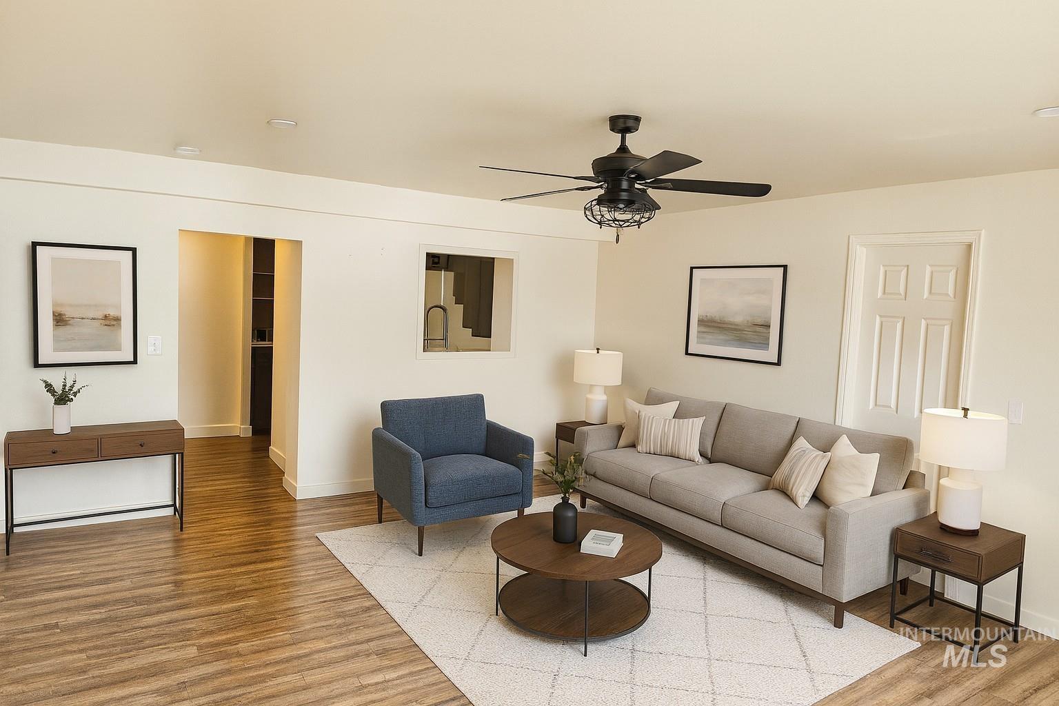 Living area featuring wood finished floors and a ceiling fan