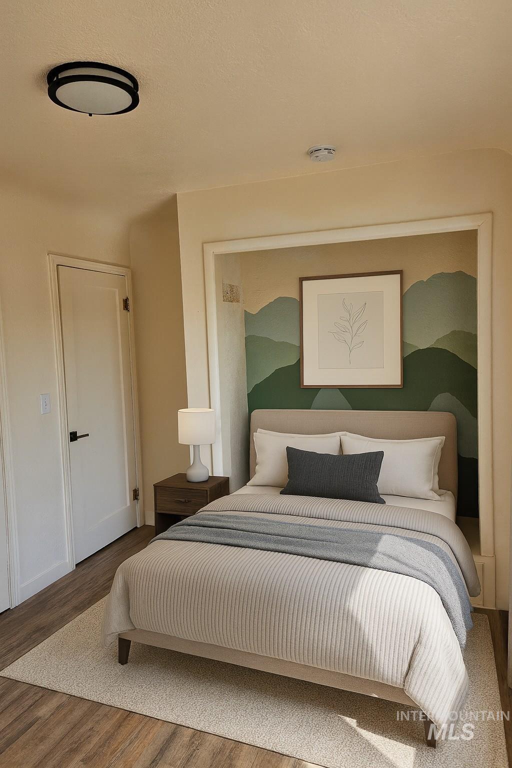 Bedroom featuring wood finished floors and baseboards
