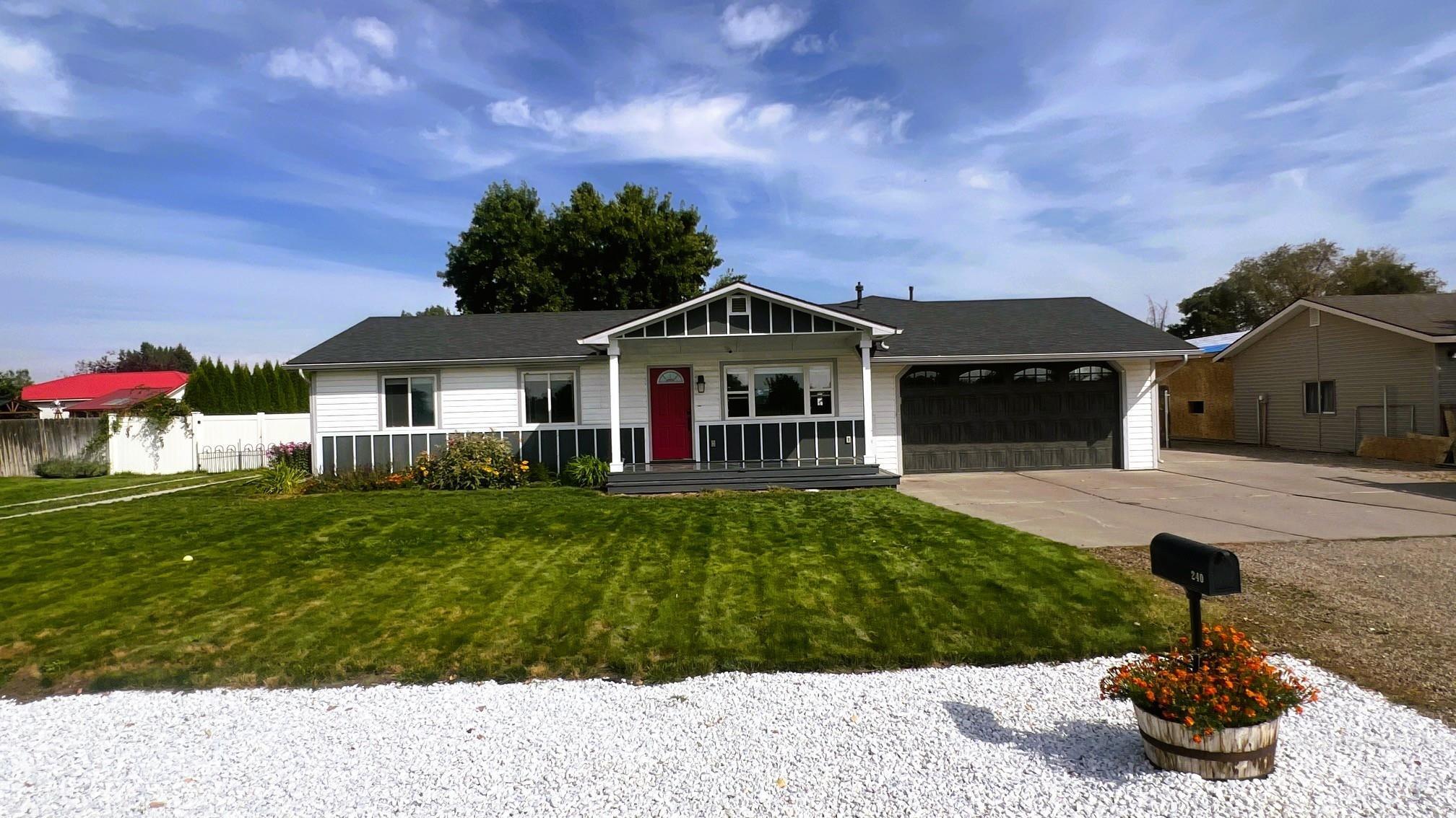 Ranch-style house with driveway, a garage, and covered porch