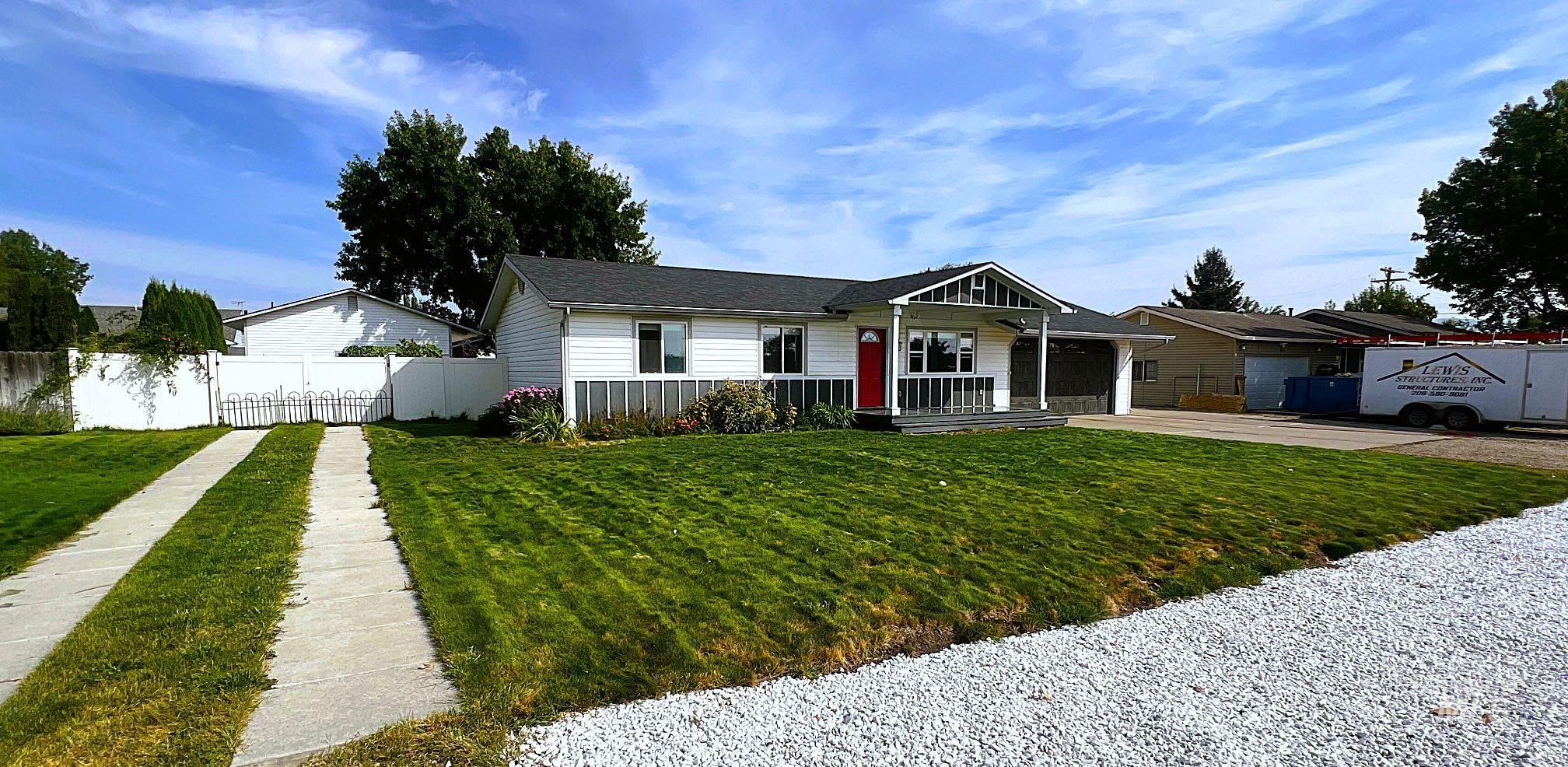 Ranch-style home featuring concrete driveway and an attached garage