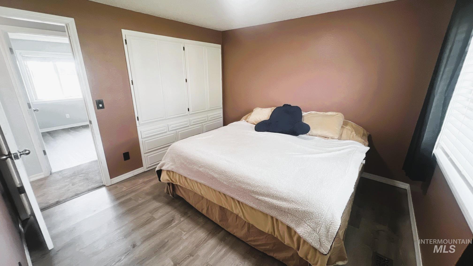 Bedroom featuring light wood-style flooring and a closet