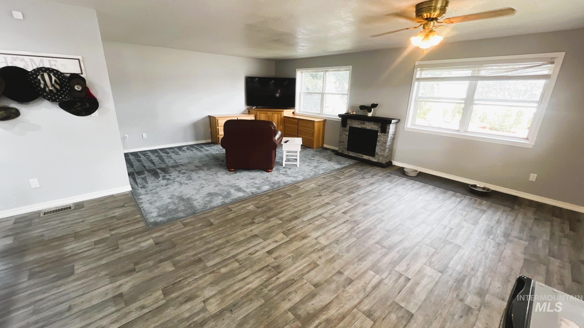 Living area with a ceiling fan and wood finished floors
