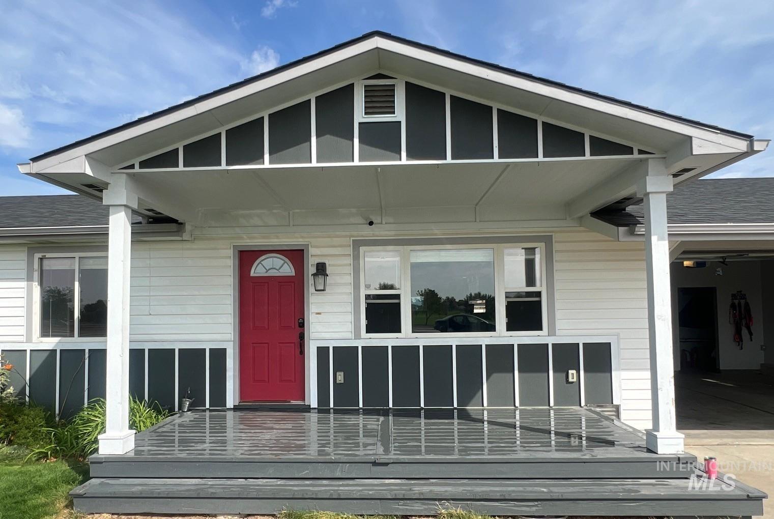 Property entrance with roof with shingles and covered porch