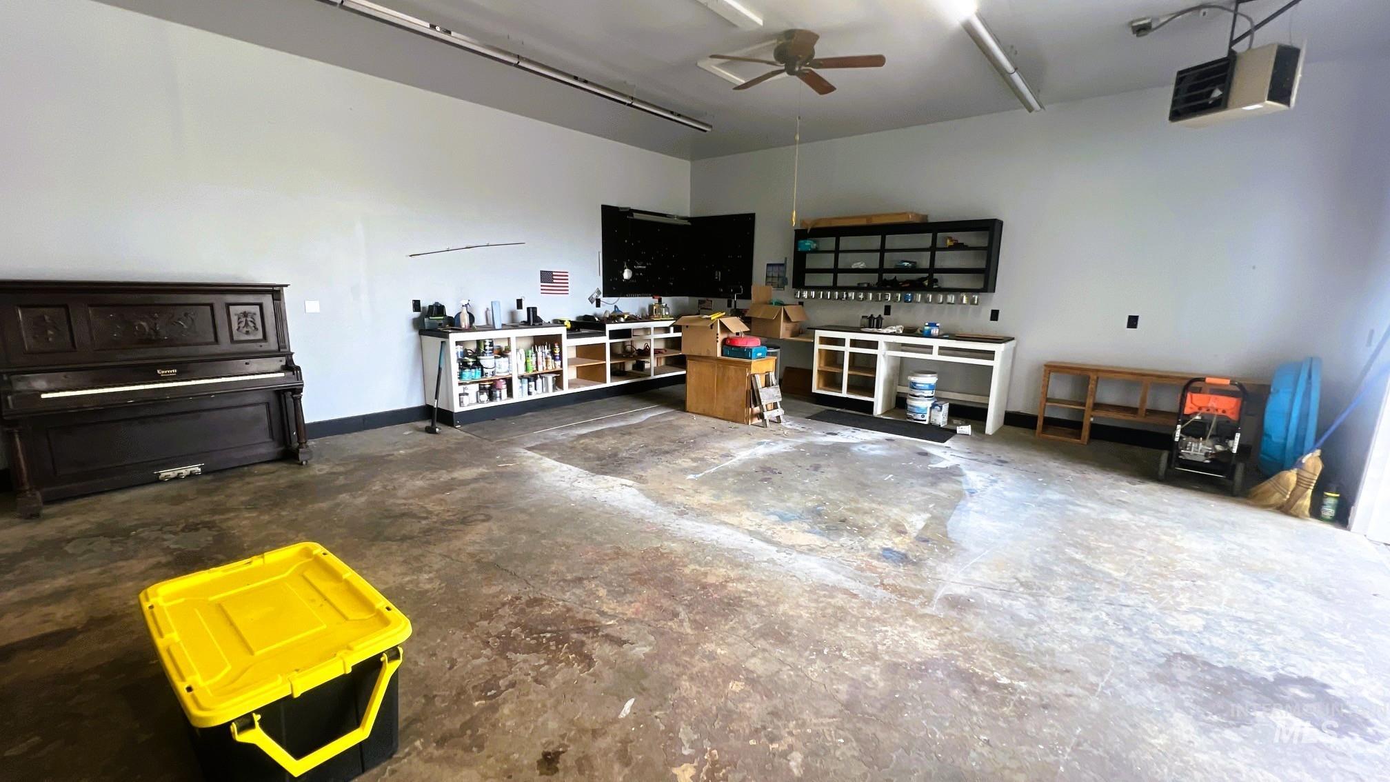 Garage with a workshop area and a garage door opener