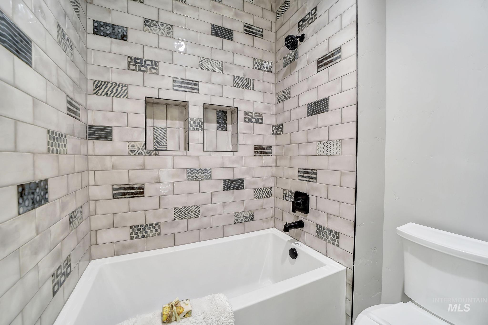 Full bathroom featuring shower / tub combination and toilet