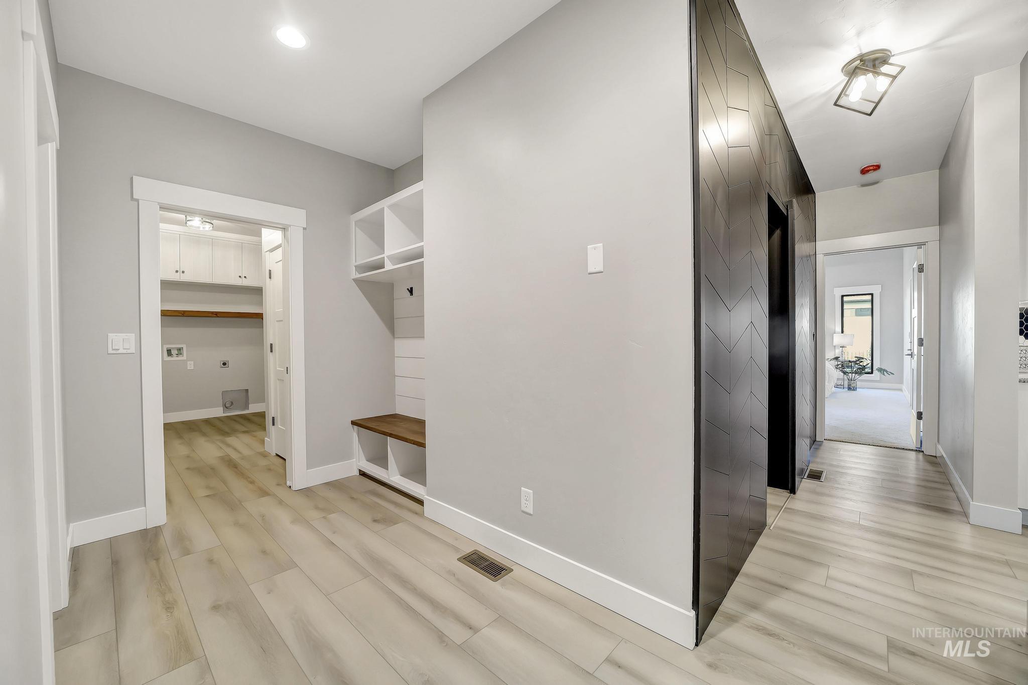 Mudroom featuring light wood finished floors and recessed lighting