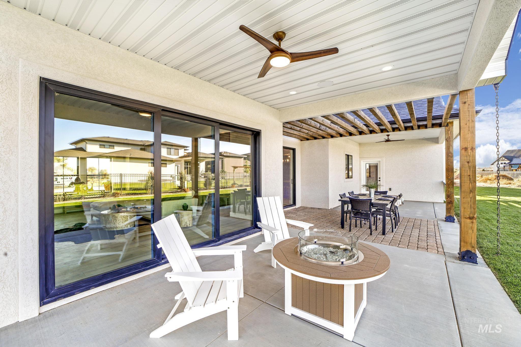View of patio with a fire pit, ceiling fan, outdoor dining space, and a pergola