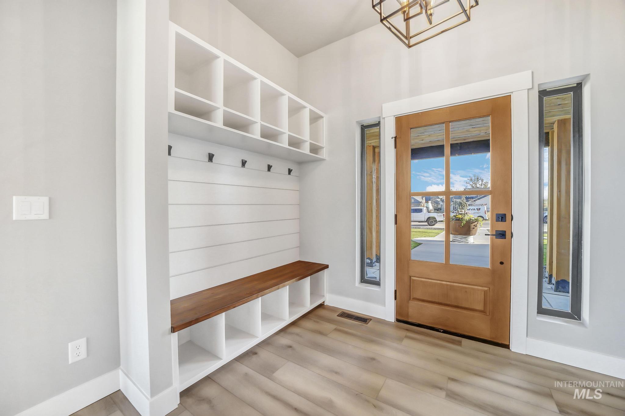 Mudroom with baseboards and light wood-style flooring