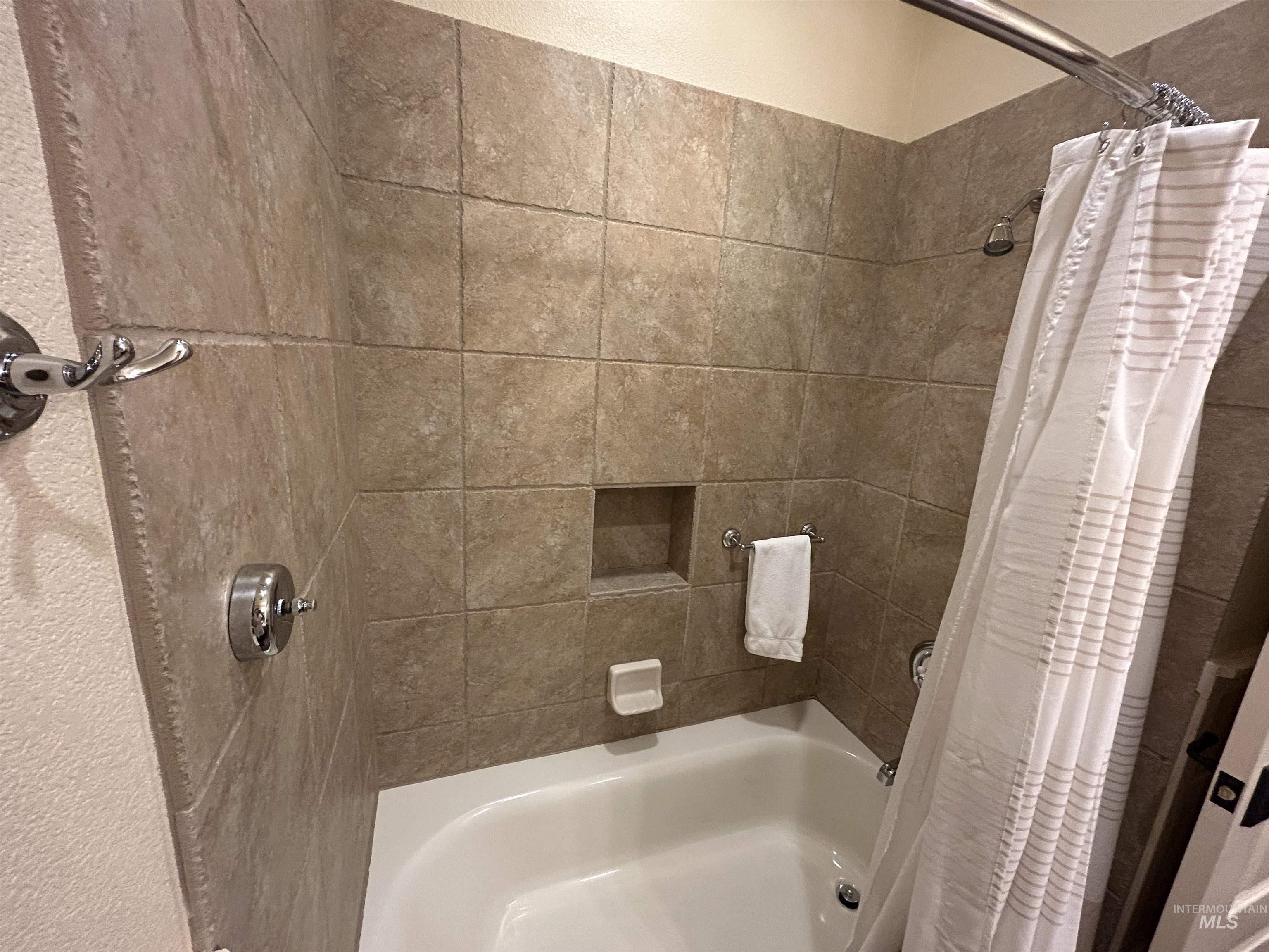 Full bathroom with shower / tub combo with curtain