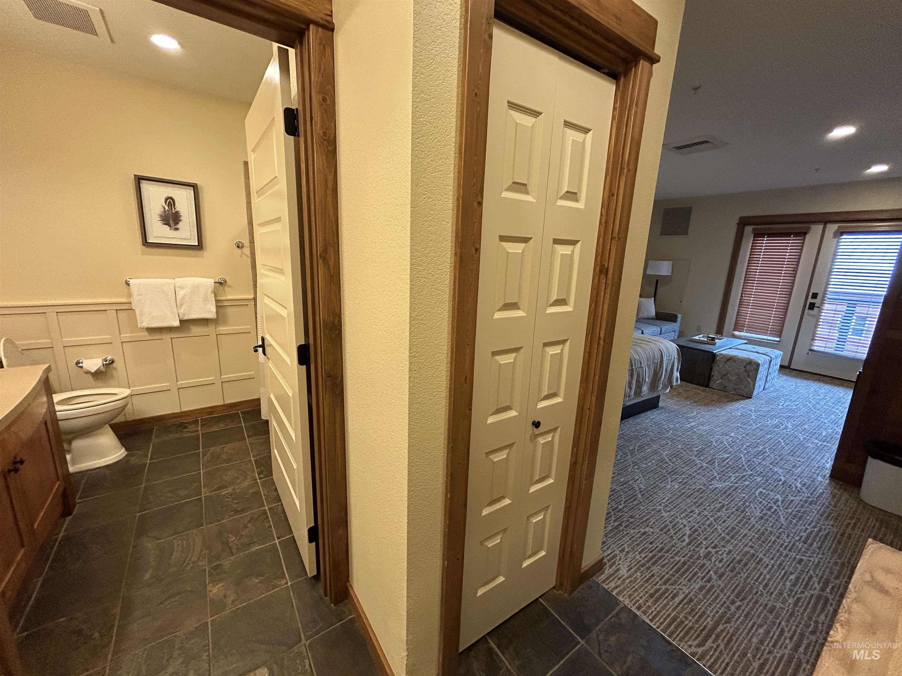 Full bathroom featuring vanity, recessed lighting, a closet, ensuite bath, and dark tile patterned floors