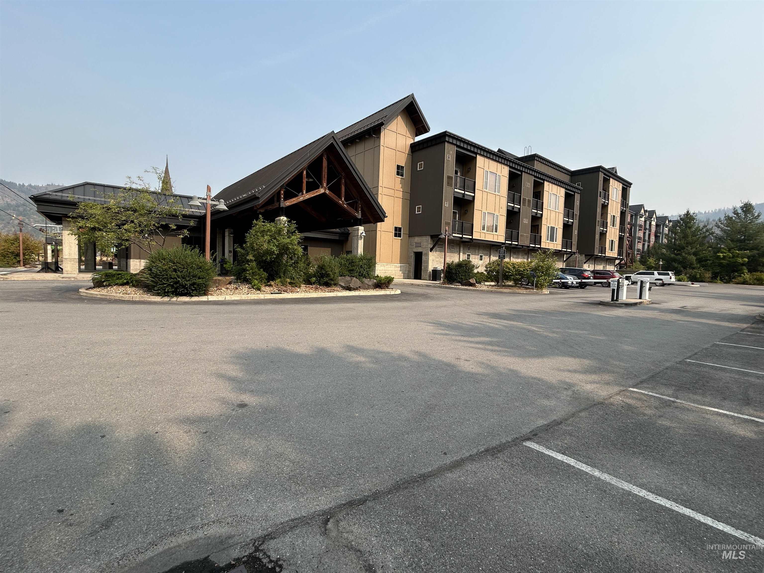 View of property featuring uncovered parking