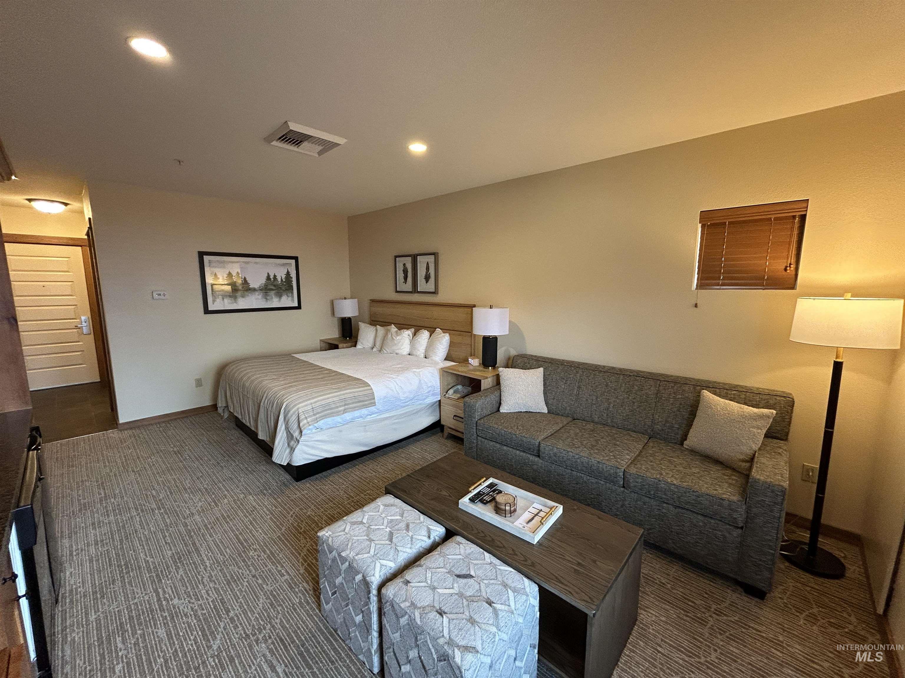 Carpeted bedroom with recessed lighting and baseboards