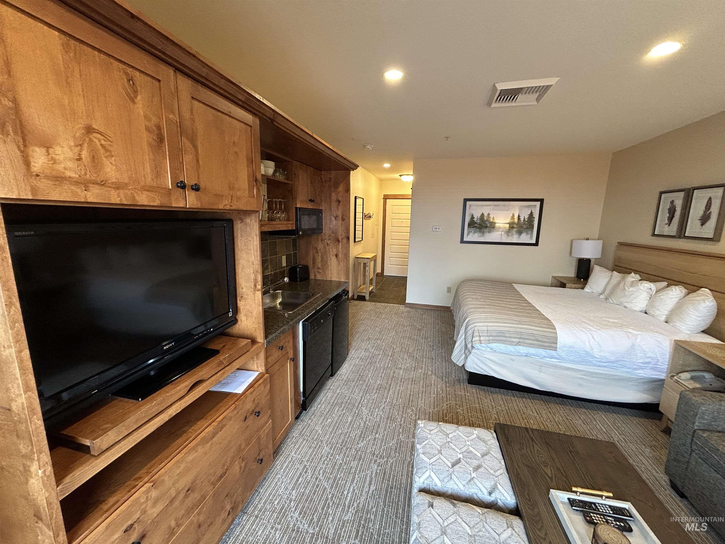 Bedroom with recessed lighting and light colored carpet