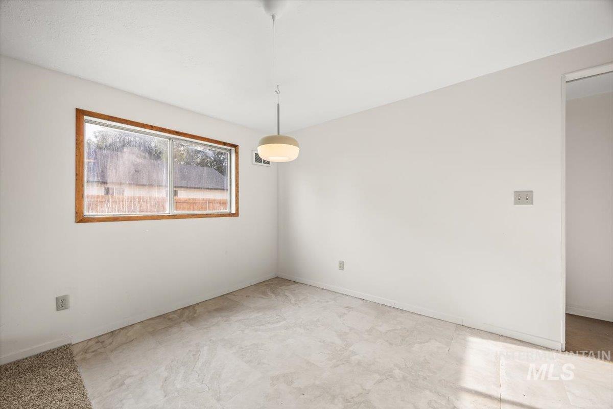 Spare room featuring baseboards