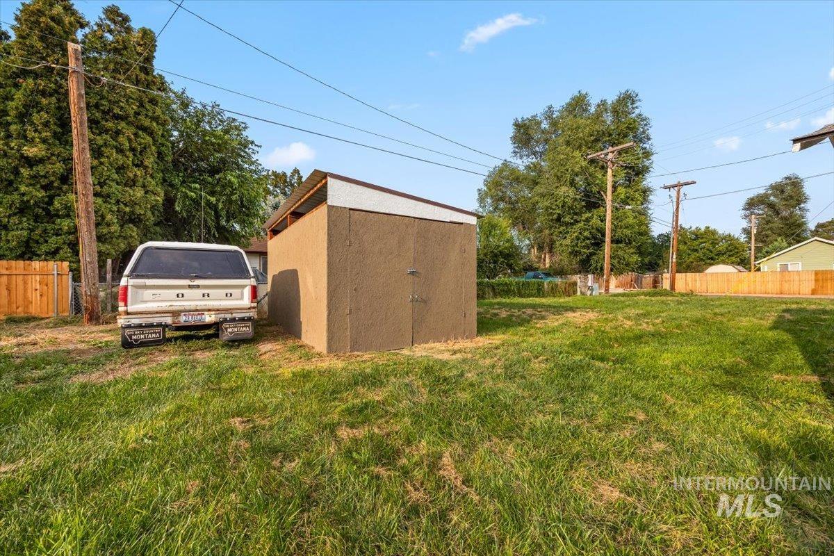 View of yard with a storage unit