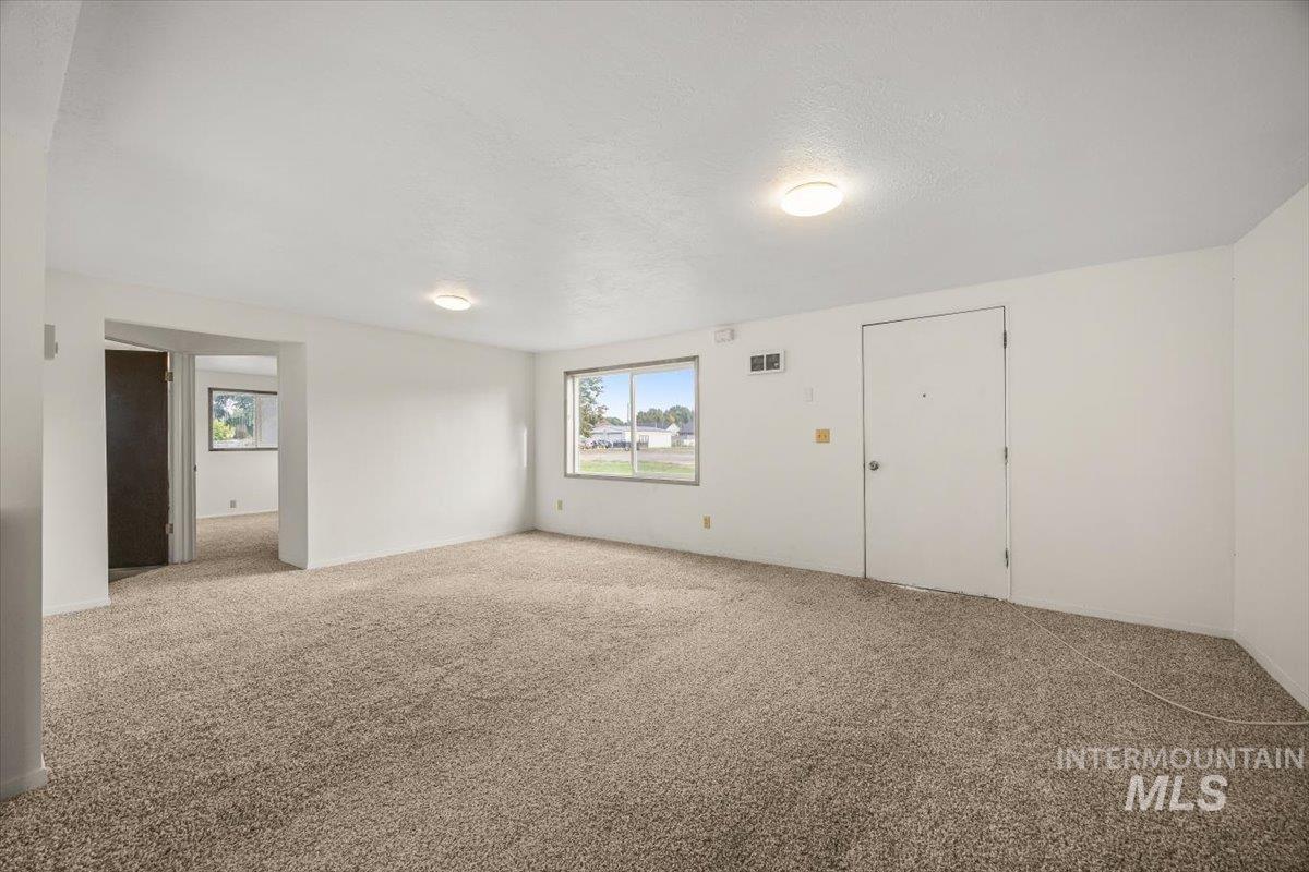 Spare room with carpet floors and a textured ceiling