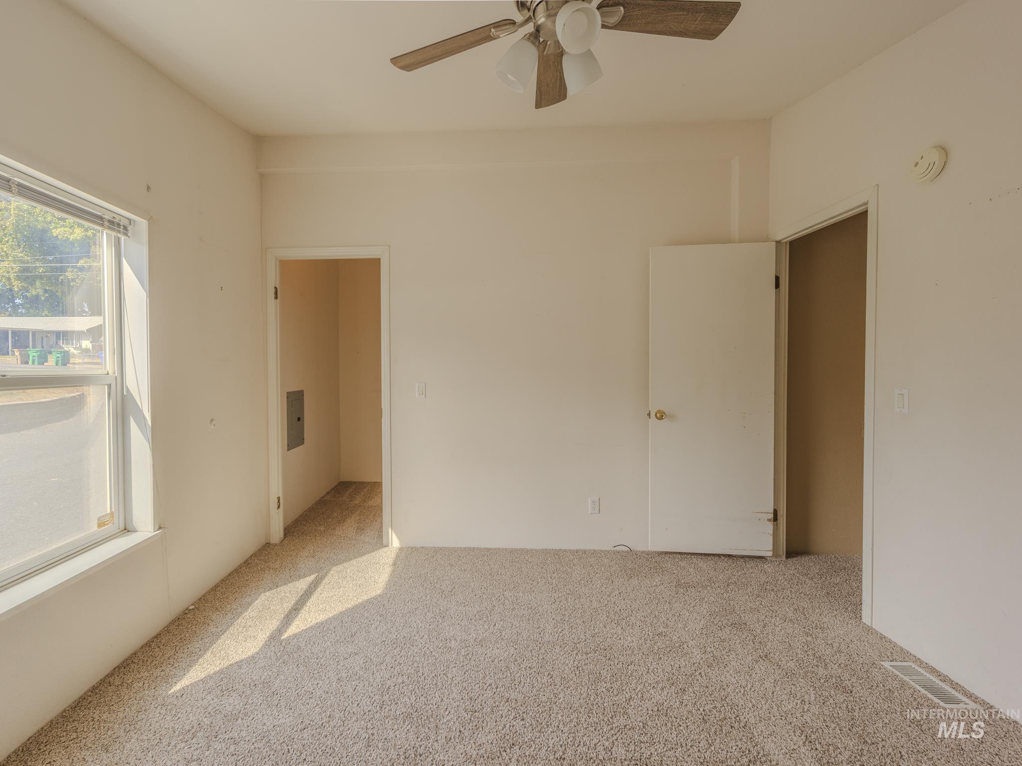 Unfurnished bedroom with carpet and ceiling fan