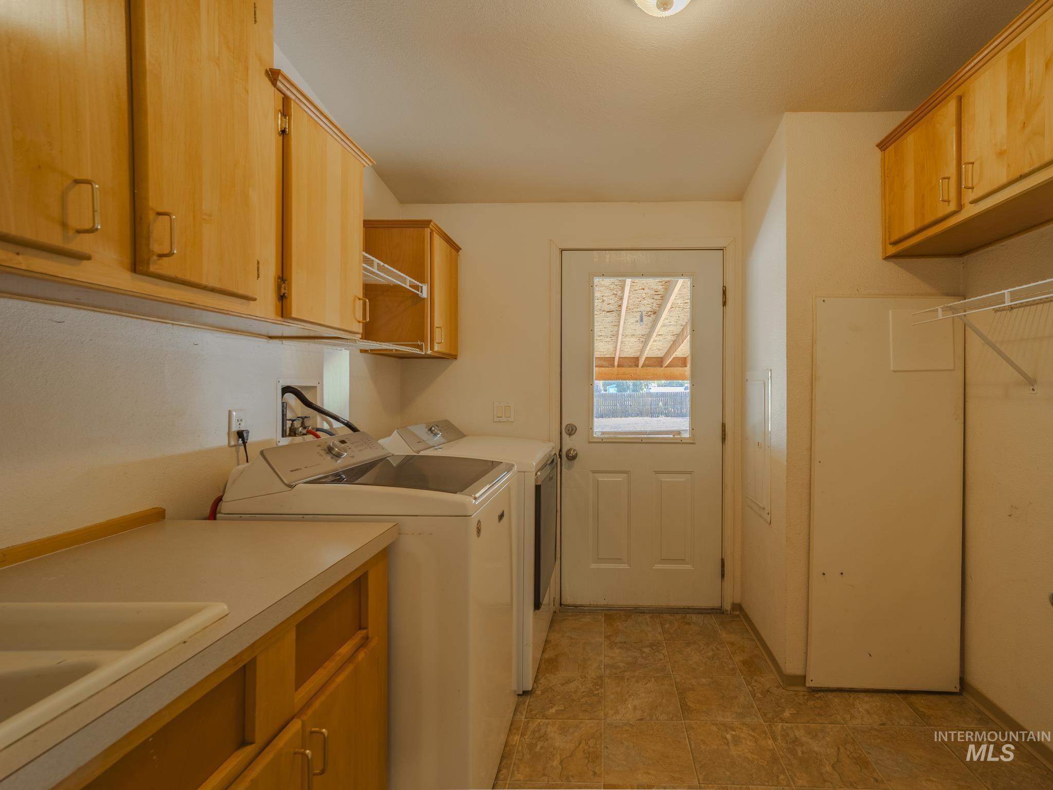 Laundry room with cabinet space and washer and clothes dryer