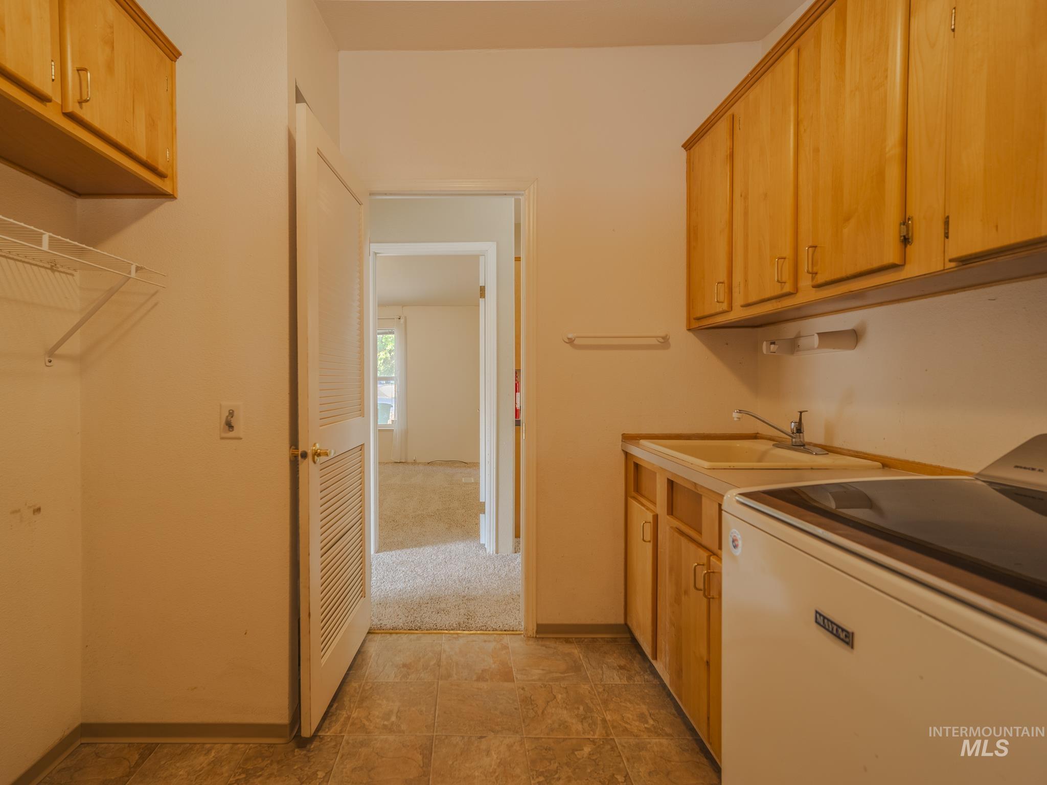 Laundry room featuring washer / dryer and cabinet space