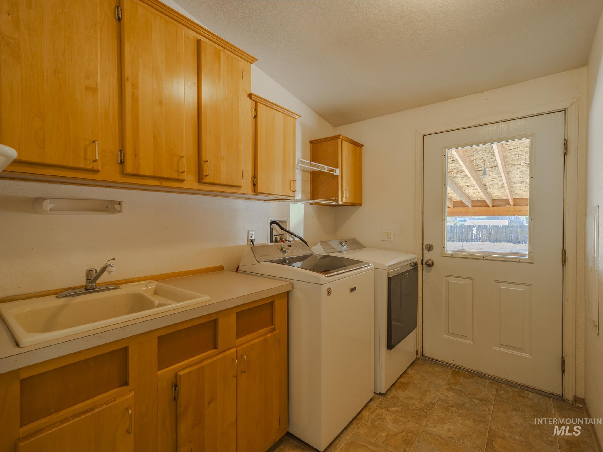 Laundry area featuring cabinet space and independent washer and dryer