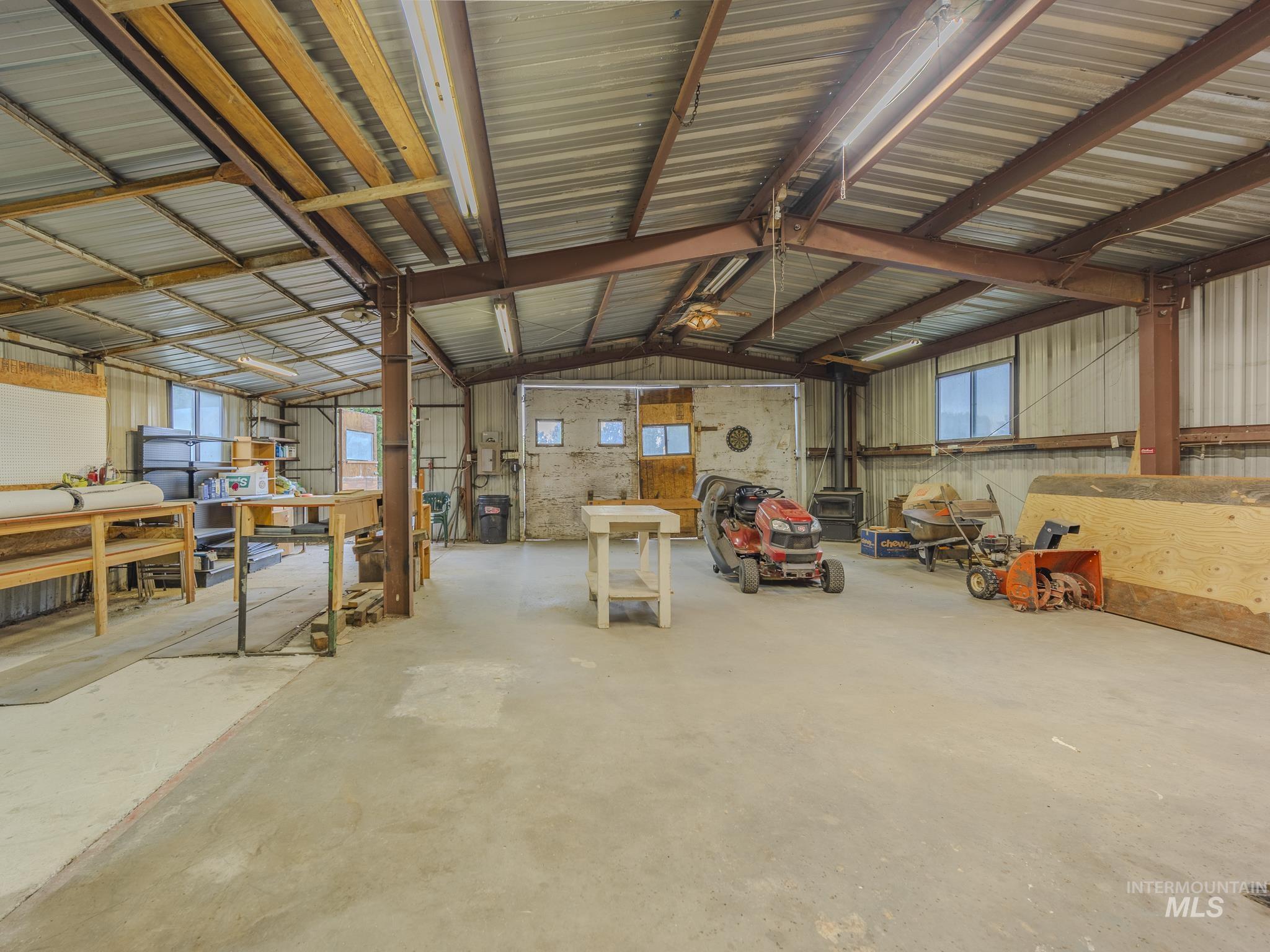 Garage featuring metal wall and a workshop area