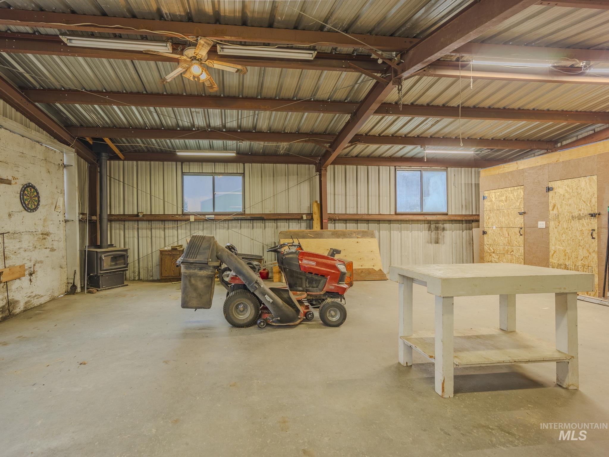 Garage with metal wall and a wood stove