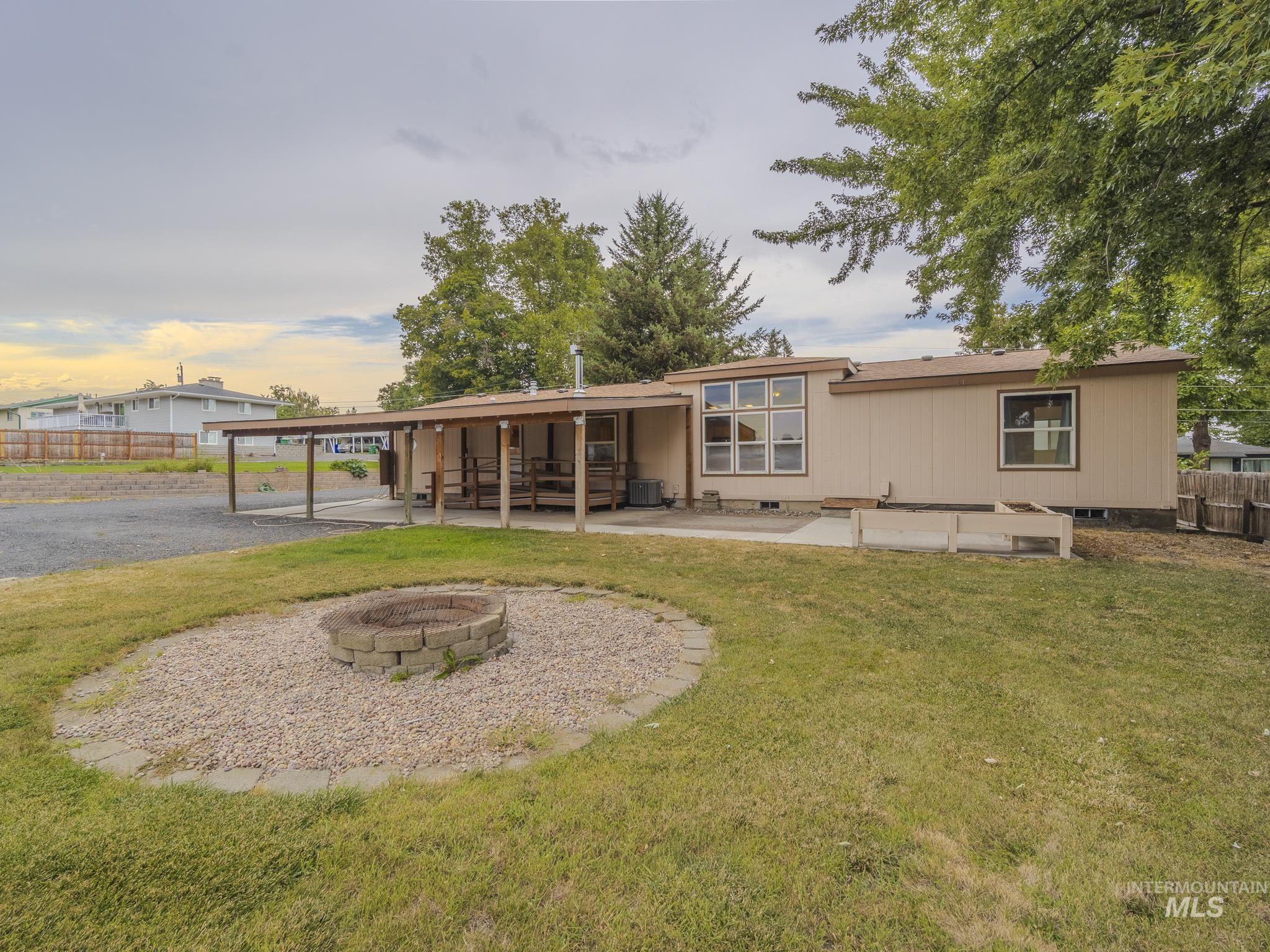 Back of house with a patio area, an outdoor fire pit, and crawl space