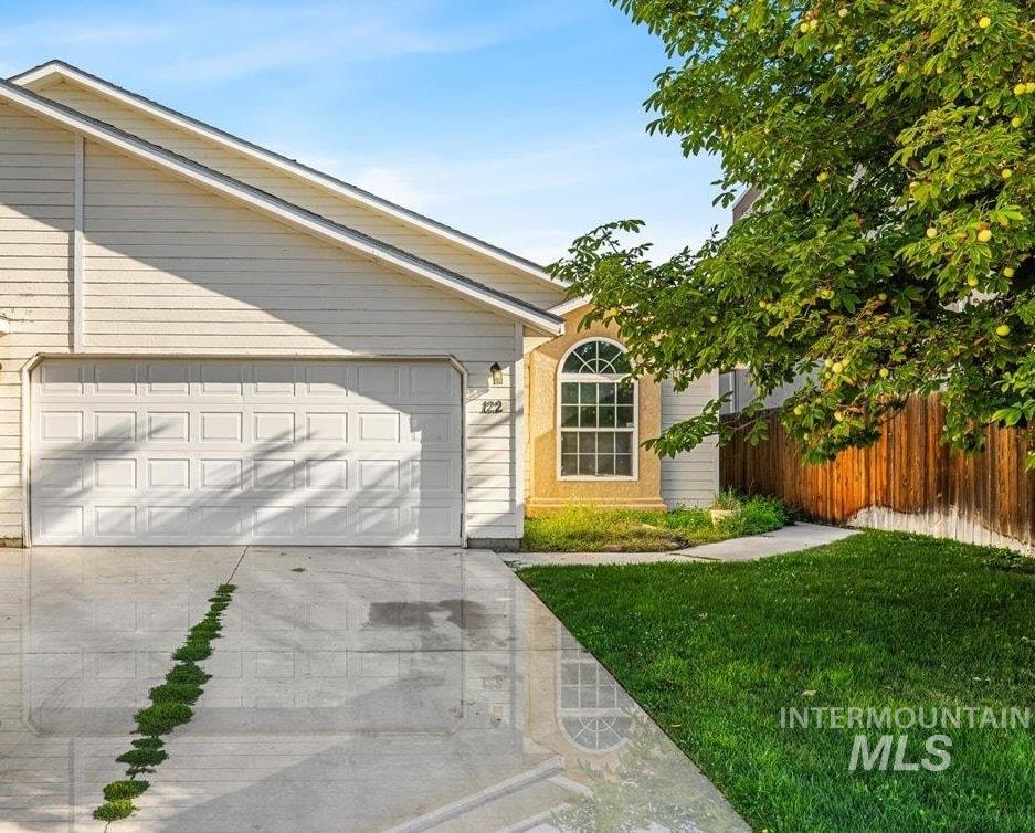 Ranch-style home featuring concrete driveway