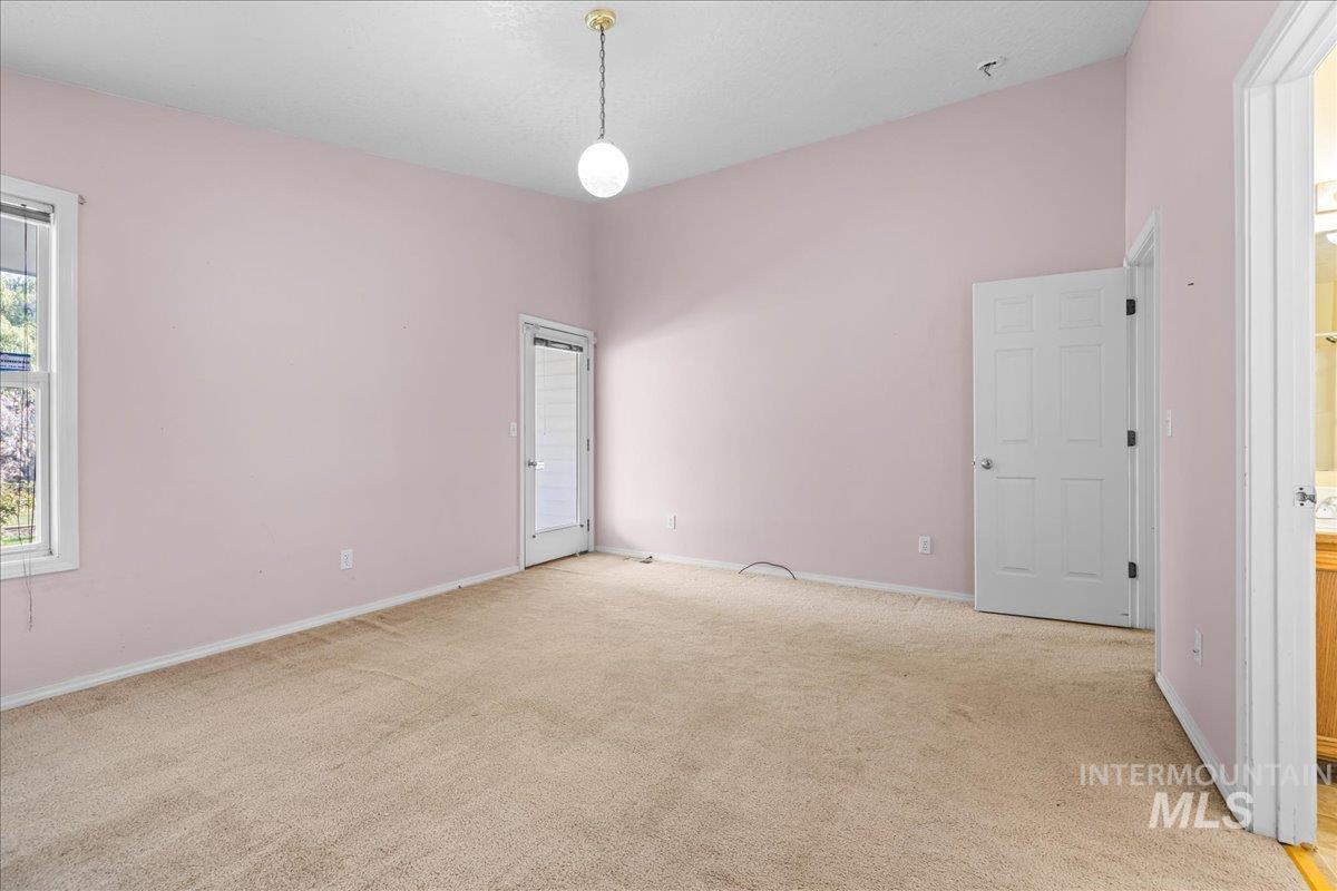 Spare room featuring light colored carpet