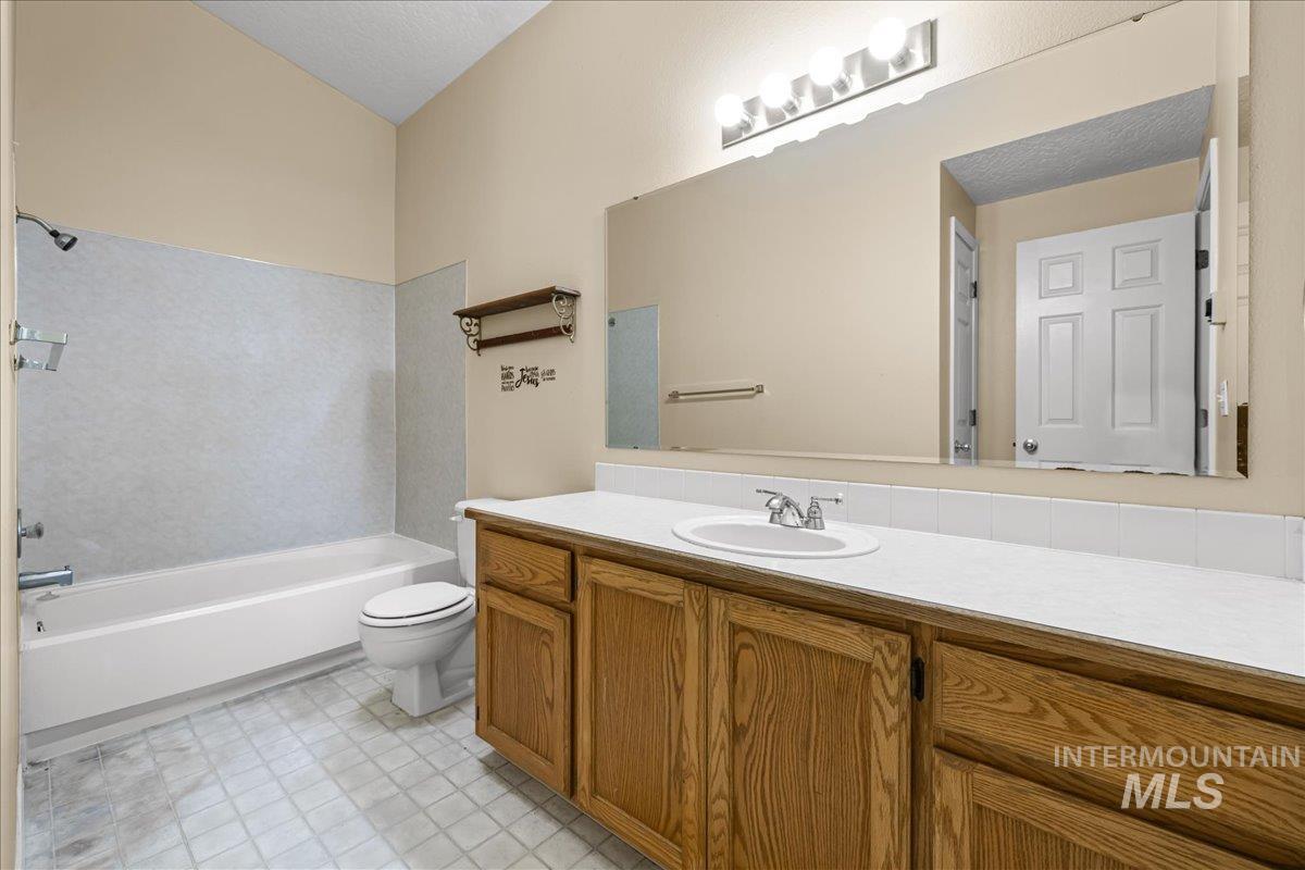 Bathroom with vanity and bathtub / shower combination