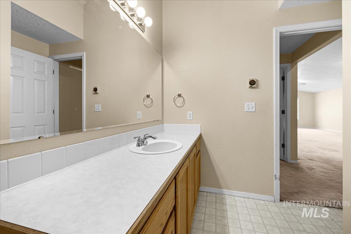 Bathroom with vanity and baseboards