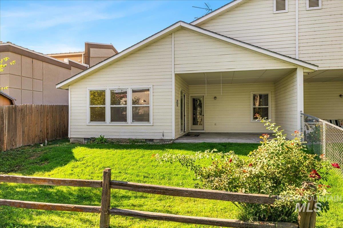 Rear view of property featuring a fenced backyard and a patio area