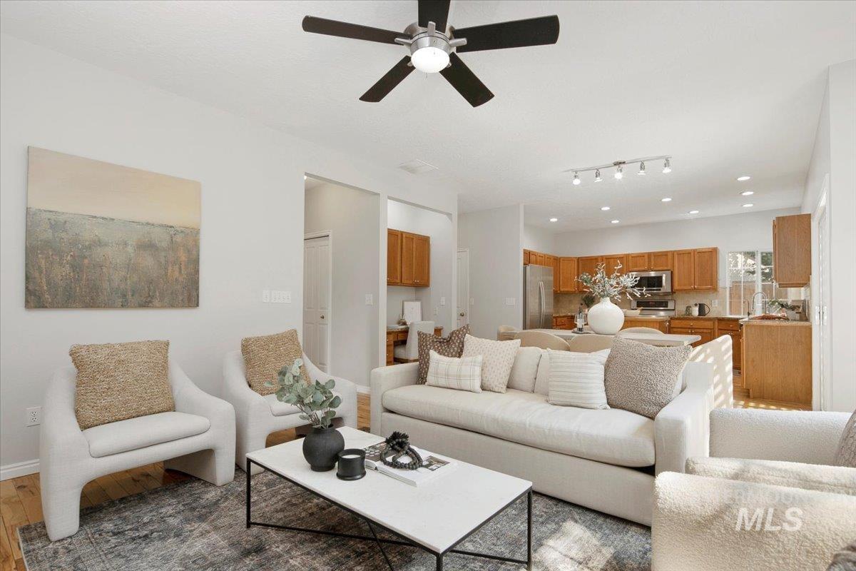 Living area featuring light wood-style floors and a ceiling fan