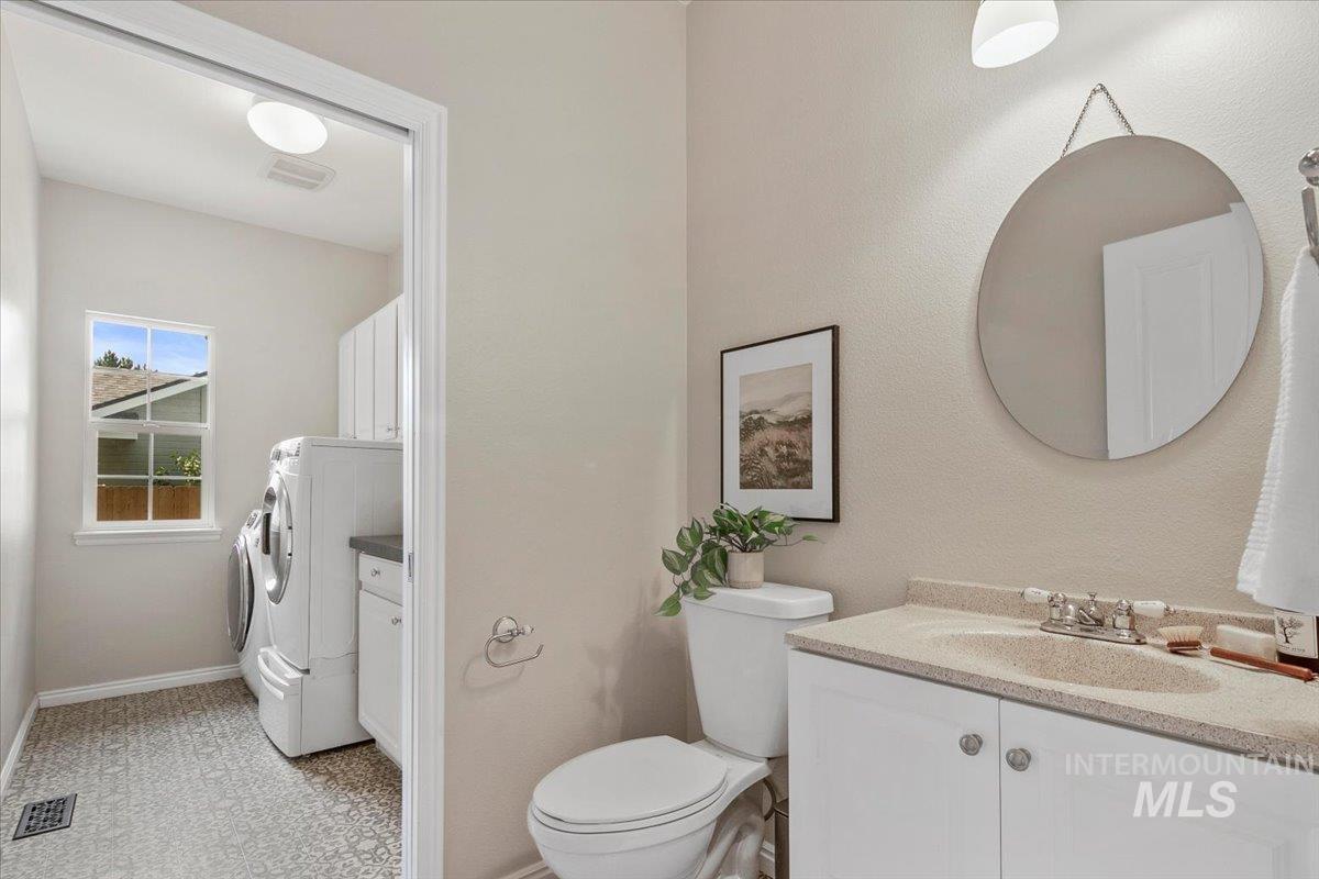 Bathroom featuring vanity and washer and clothes dryer