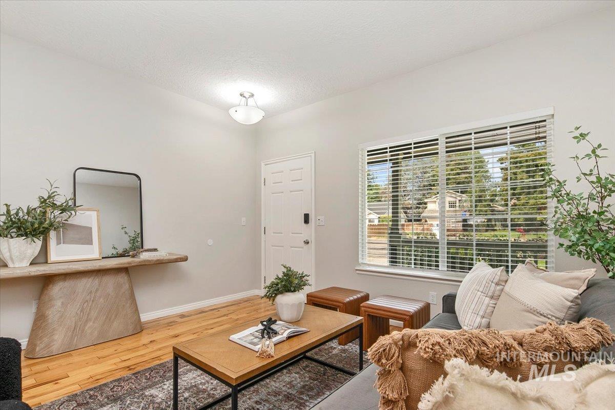 Living room with wood finished floors and a textured ceiling
