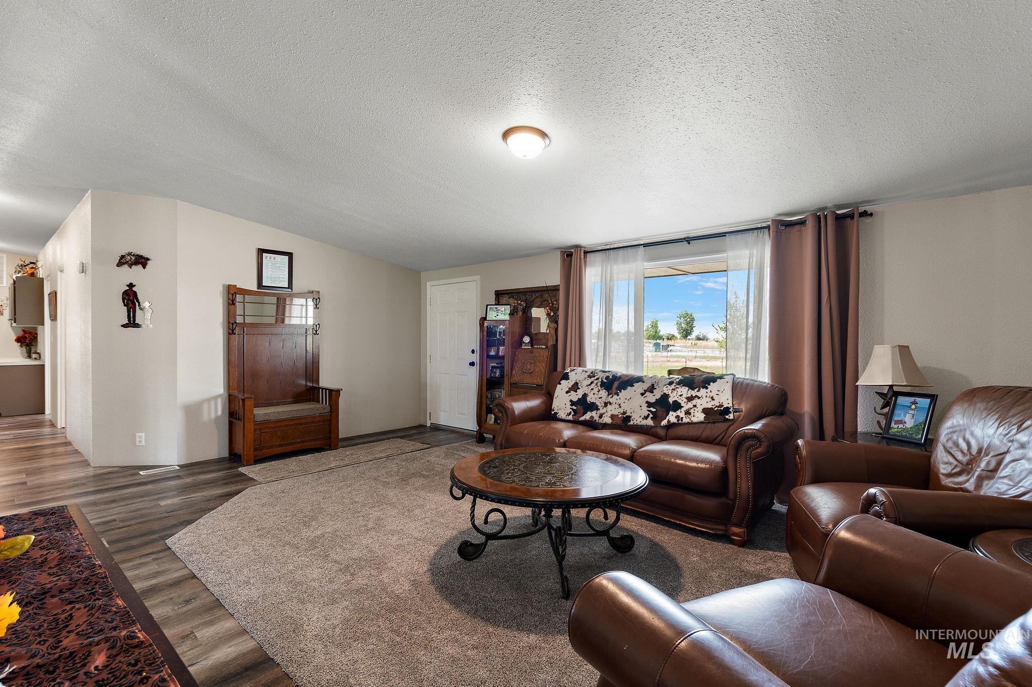 Living area with a textured ceiling and wood finished floors
