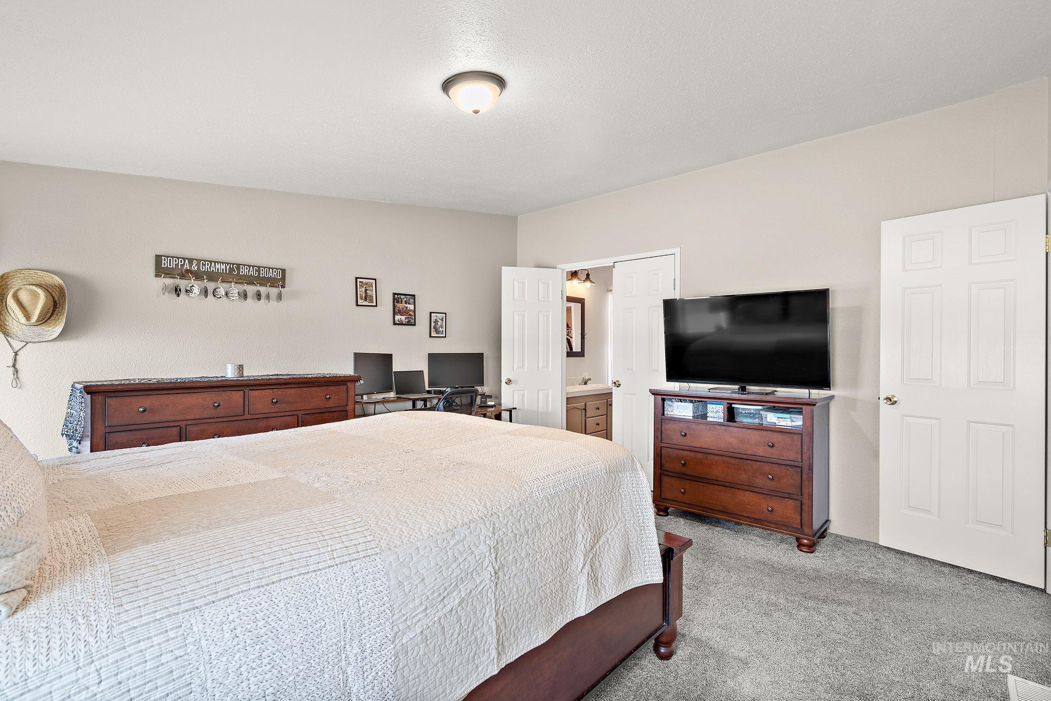 Bedroom with carpet flooring and ensuite bath