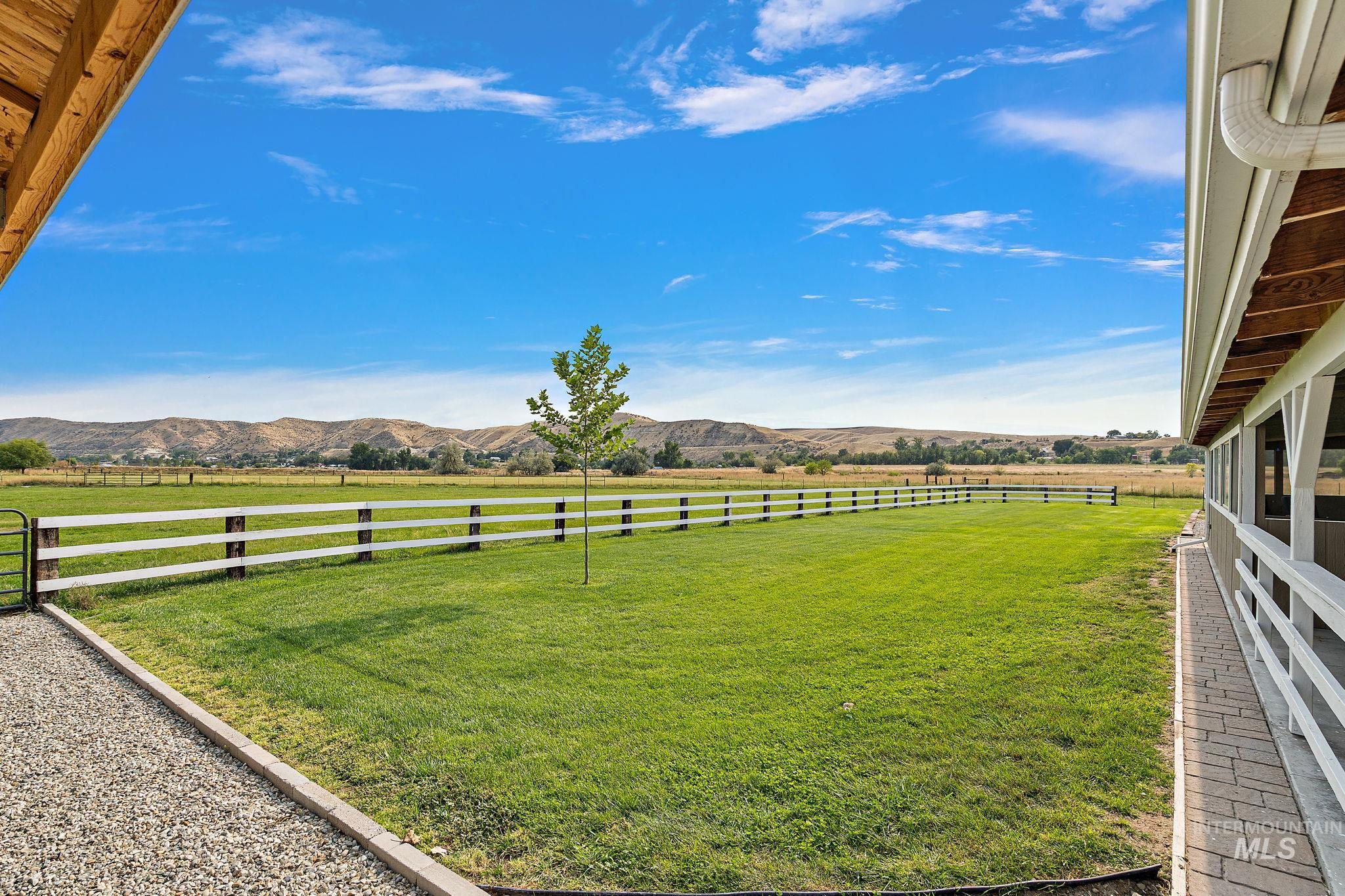 View of yard with a mountain view and a rural view