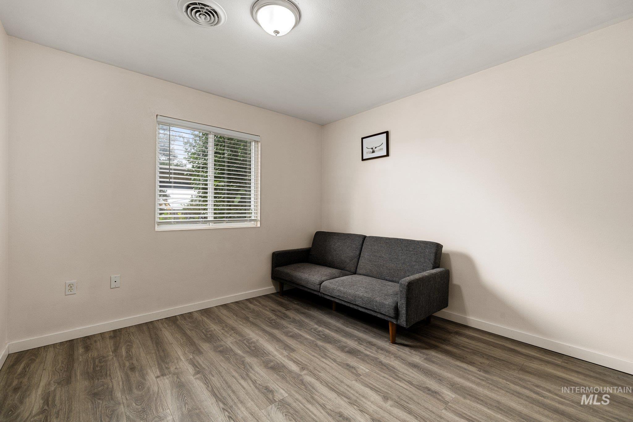 Sitting room featuring wood finished floors and baseboards