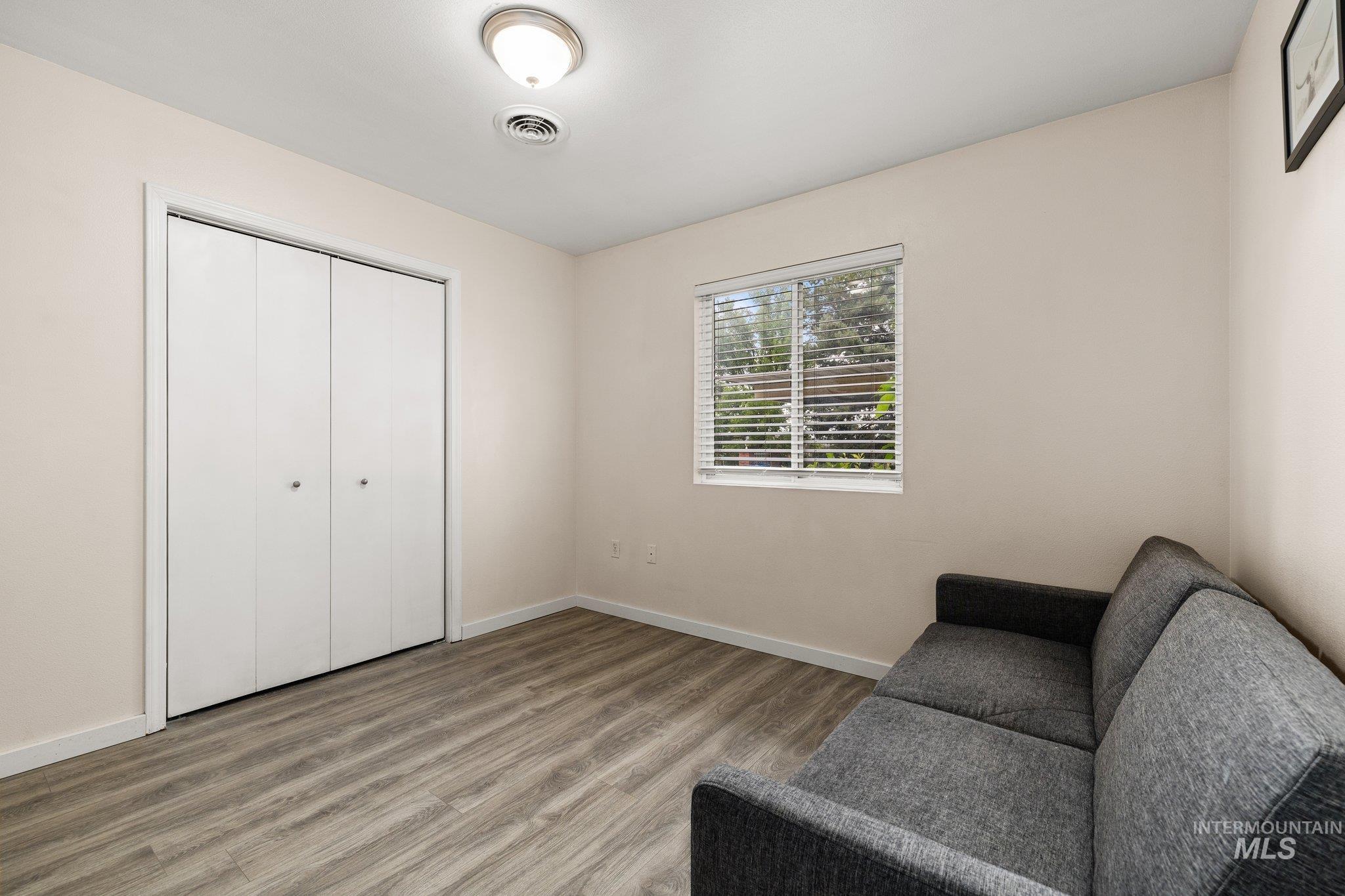 Living area featuring wood finished floors and baseboards