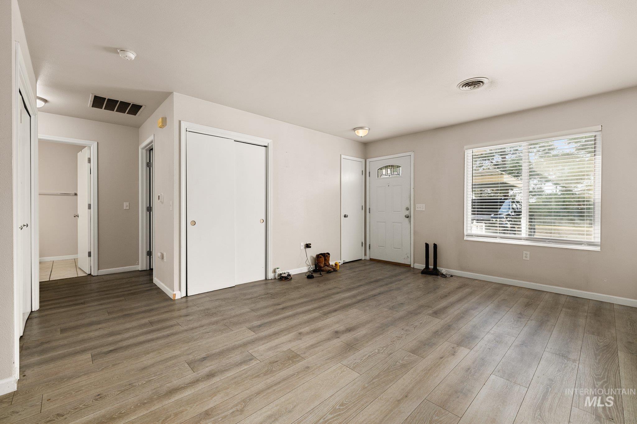 Foyer entrance with baseboards and light wood finished floors