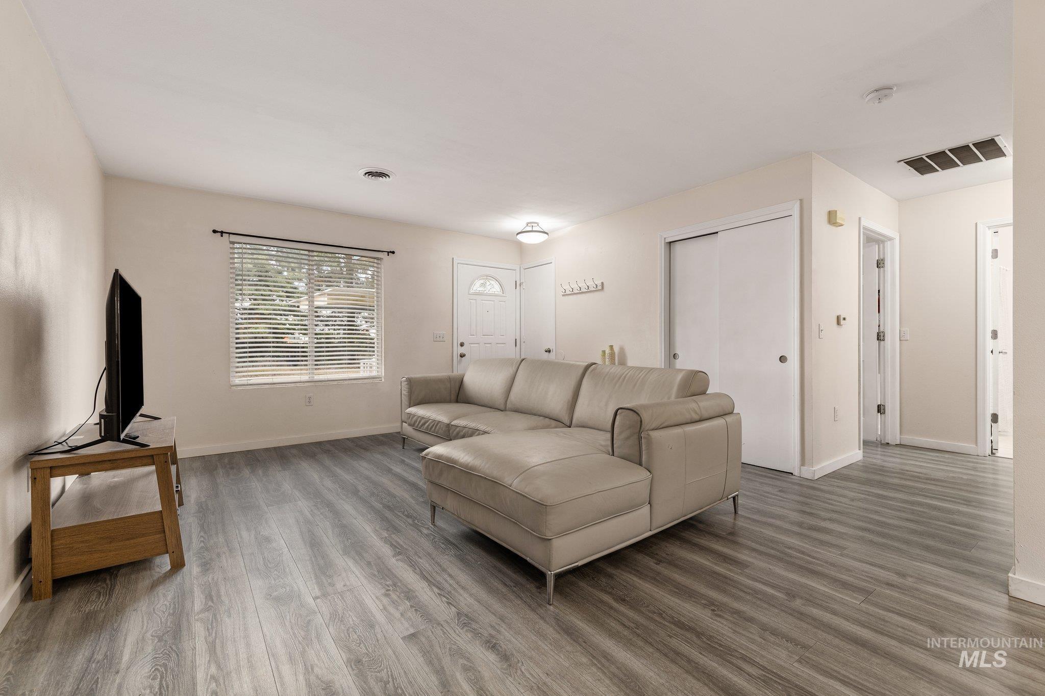 Living room featuring wood finished floors and baseboards