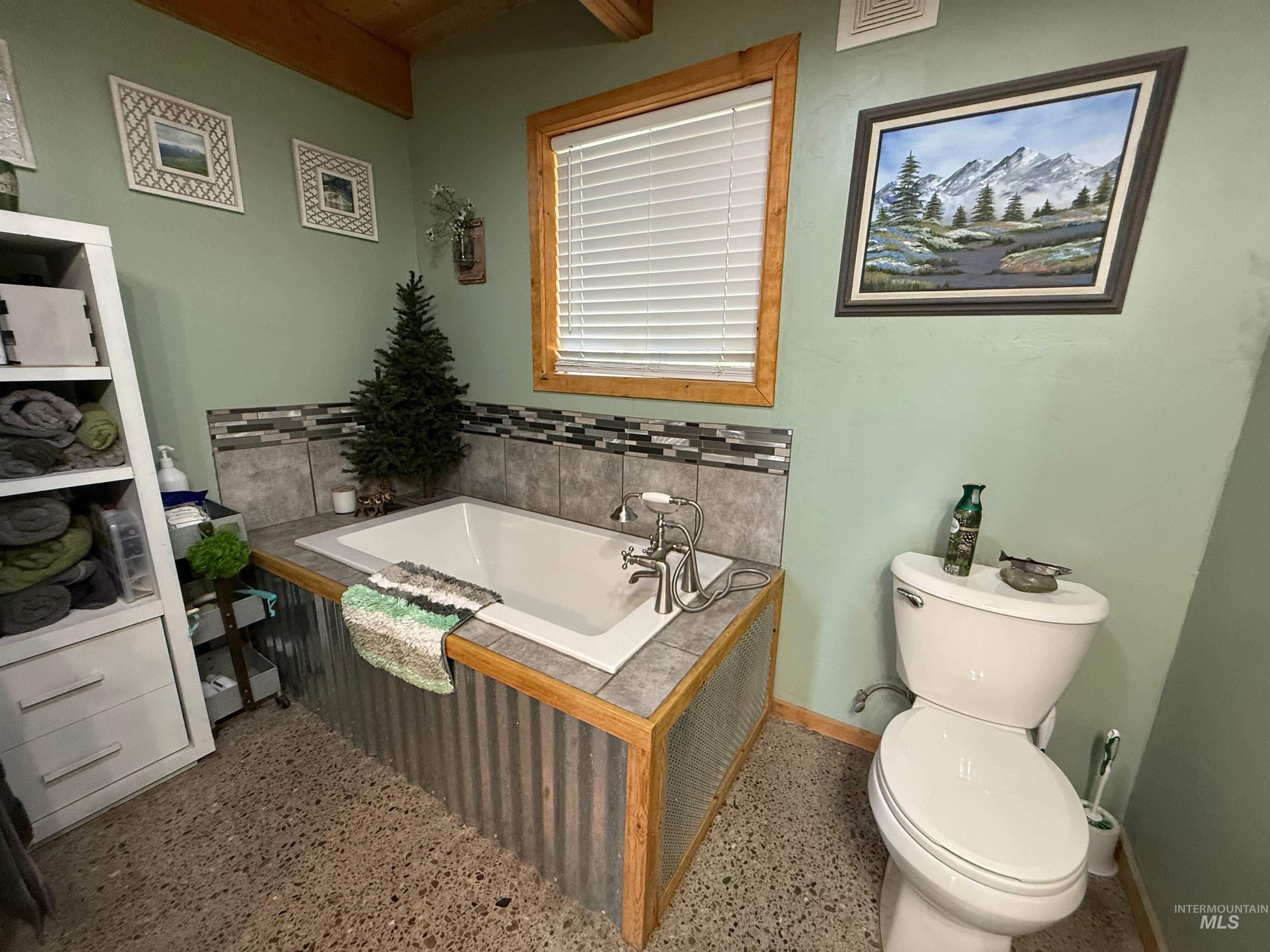 Full bath featuring a bath and beamed ceiling