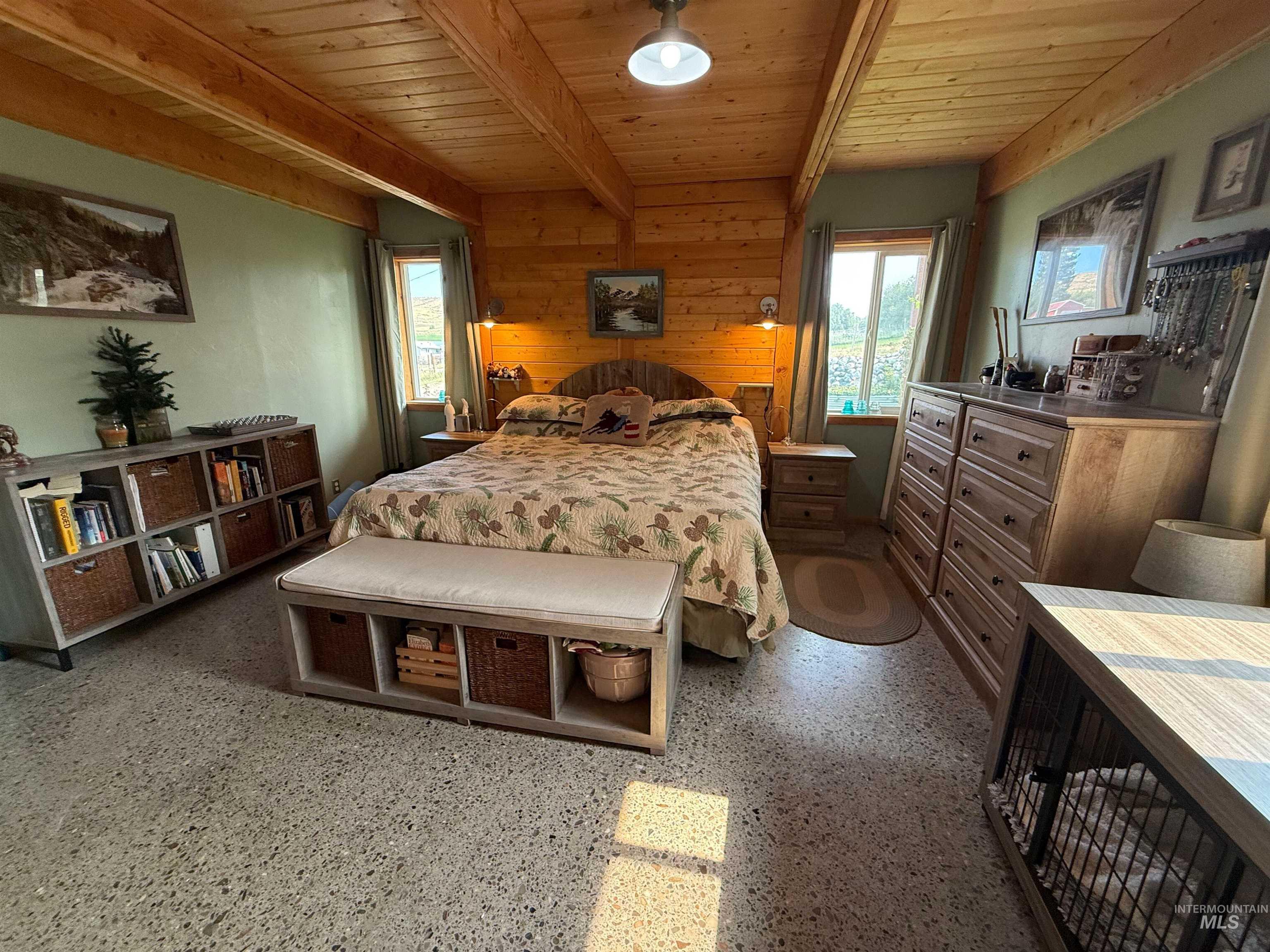 Bedroom featuring a wood ceiling with exposed beams and wood walls