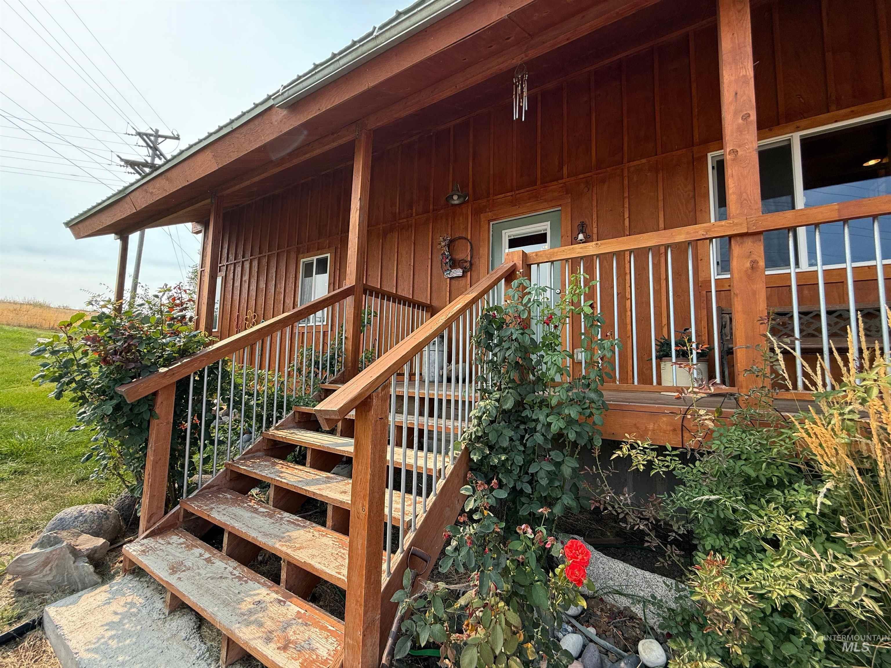 Doorway to property with a porch and board and batten siding