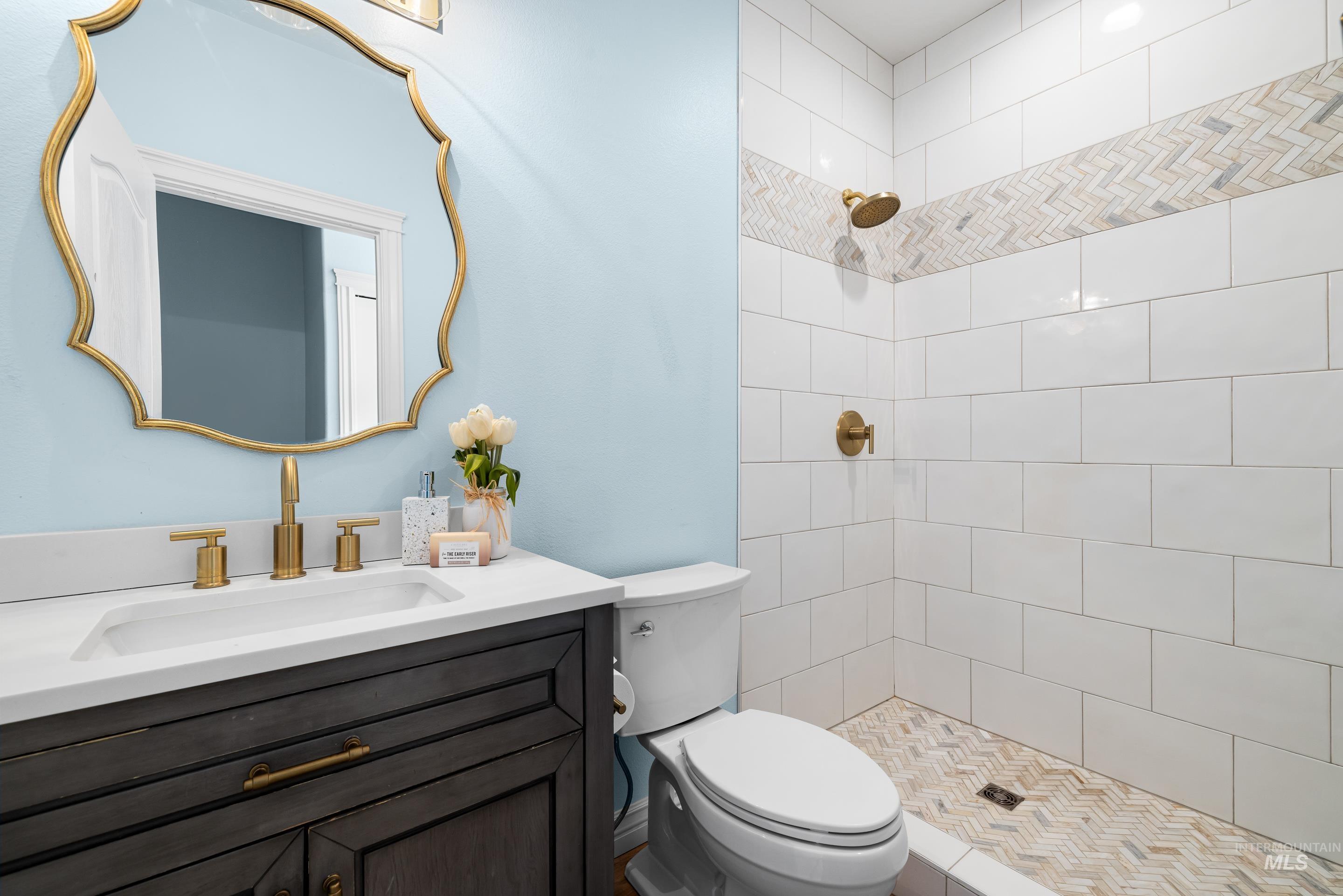 Bathroom with a shower stall and vanity