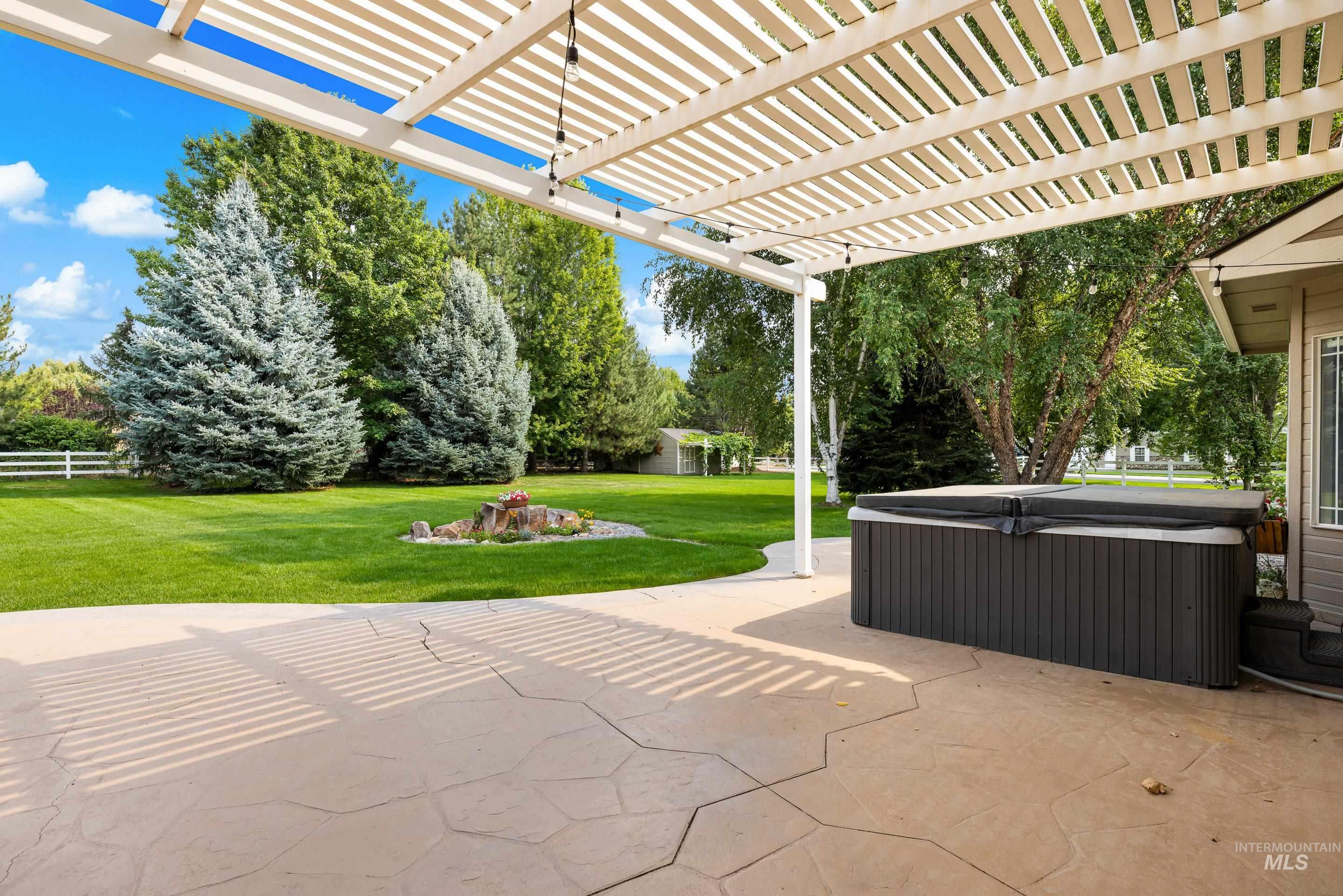 View of patio featuring a hot tub and a pergola