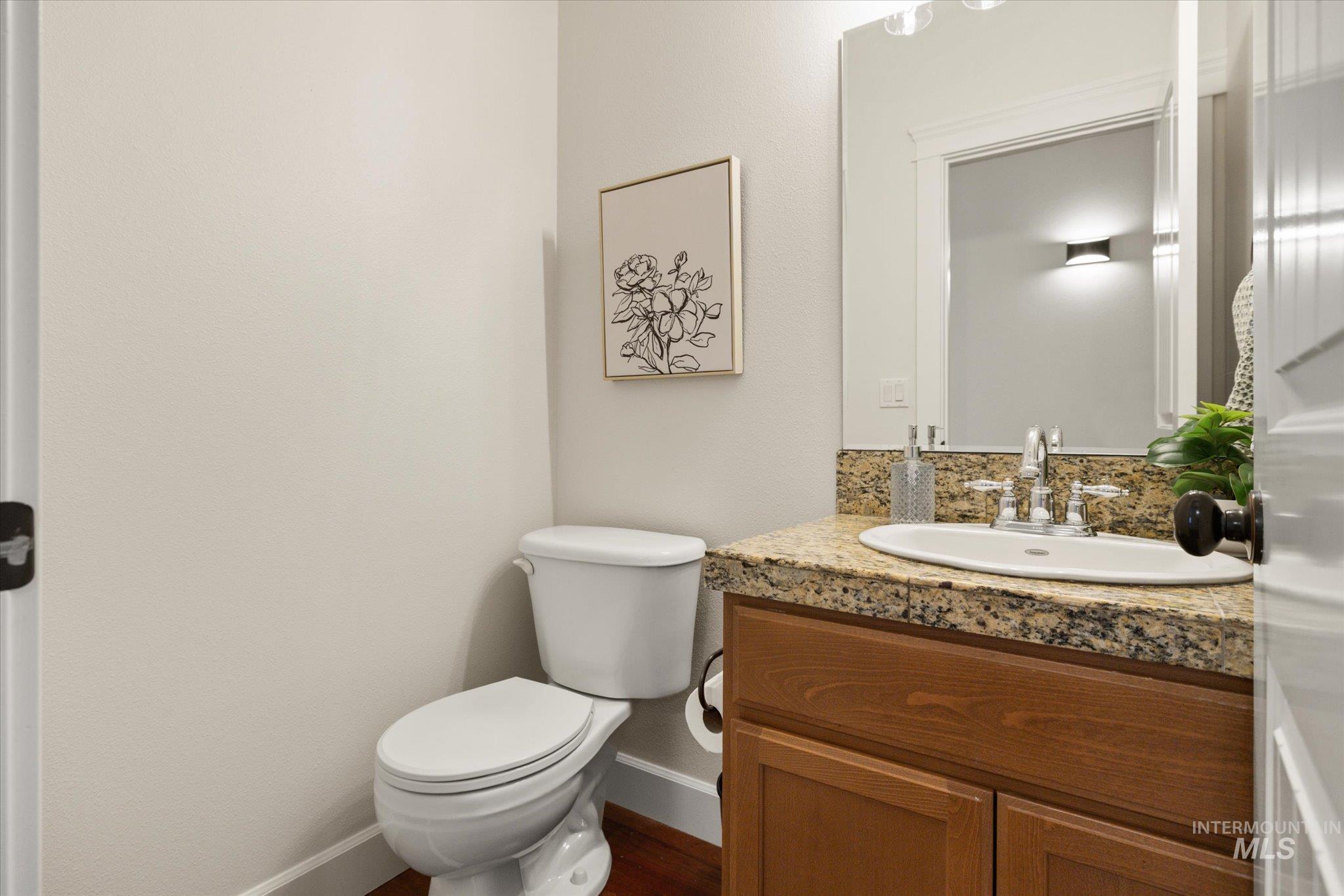 Bathroom featuring vanity and tasteful backsplash