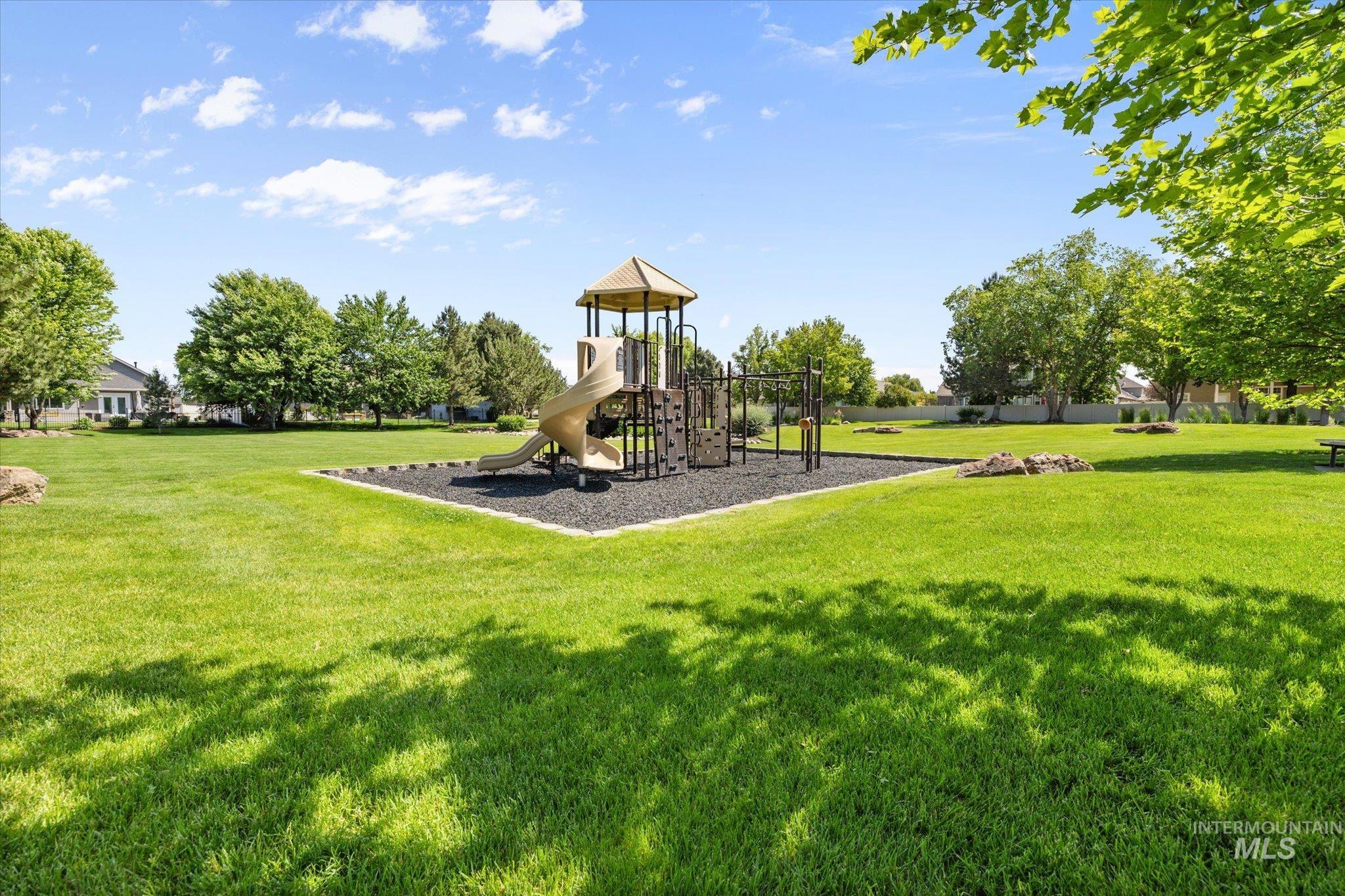 Community playground featuring a lawn