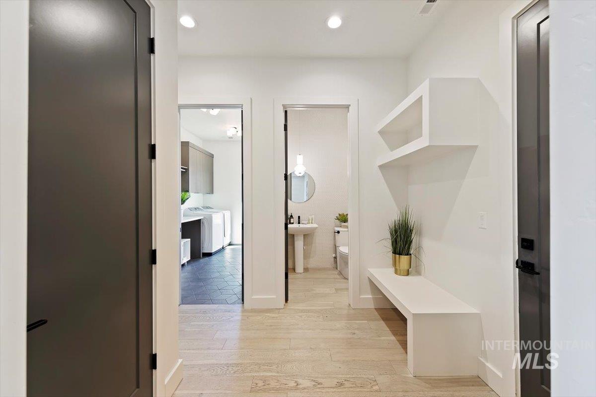 Mudroom featuring light wood-style floors and recessed lighting
